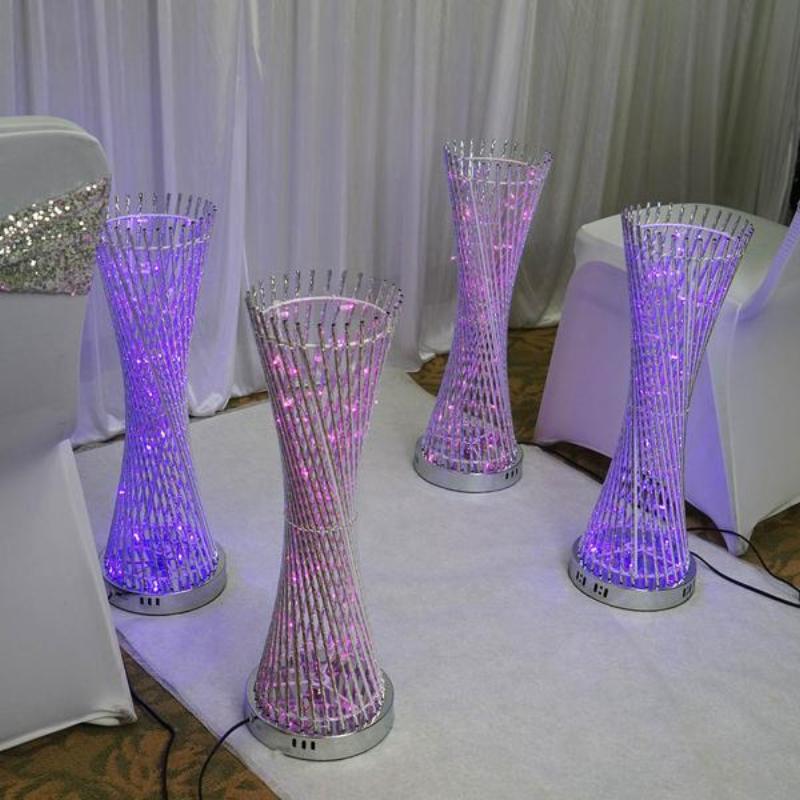 Color changing LED spiral metal tower columns in purple hues.