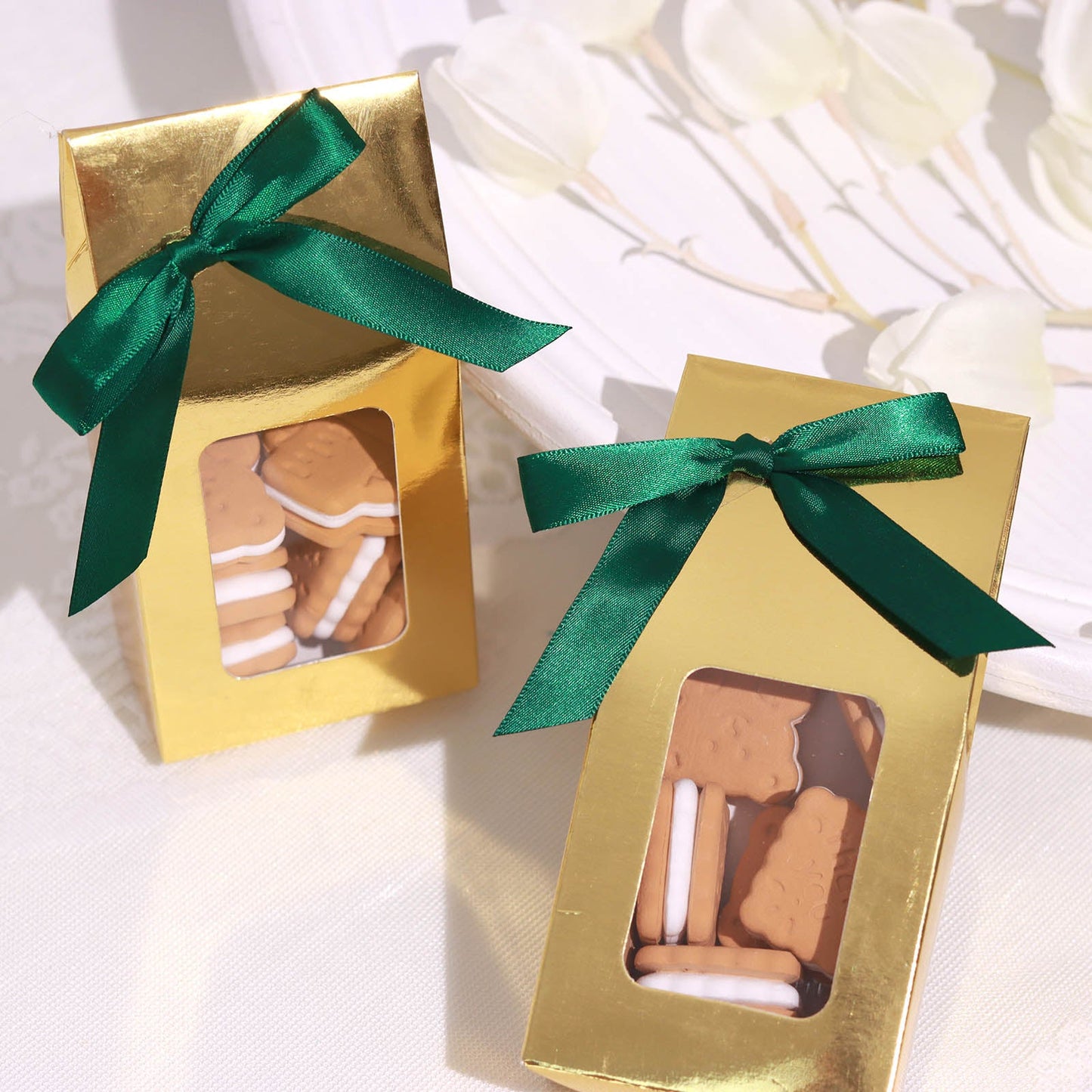 Hunter emerald green satin ribbon bows on gift boxes.