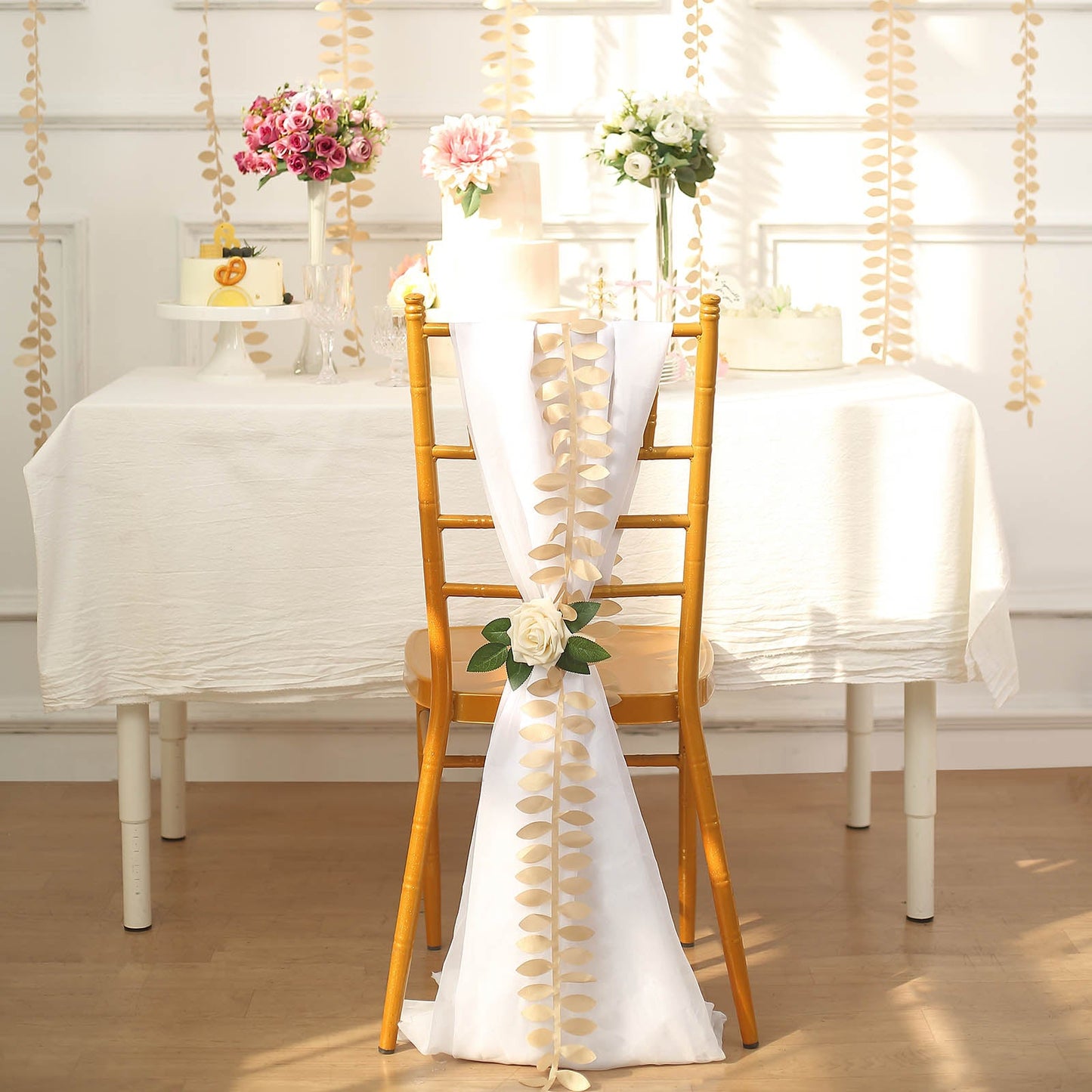 Champagne leaf petal taffeta ribbon sash on a decorated chair.