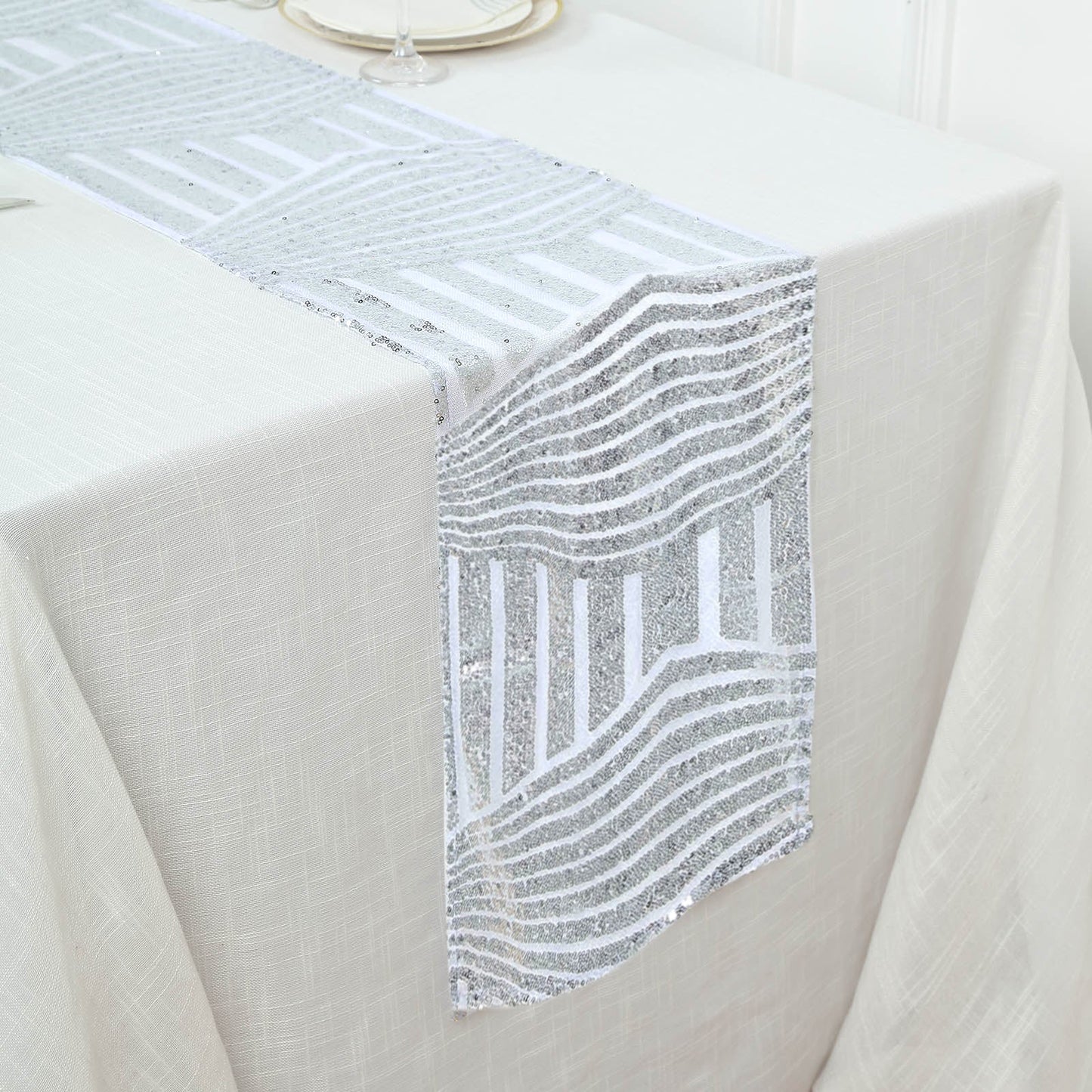 Silver diamond glitz sequin table runner on a white table.