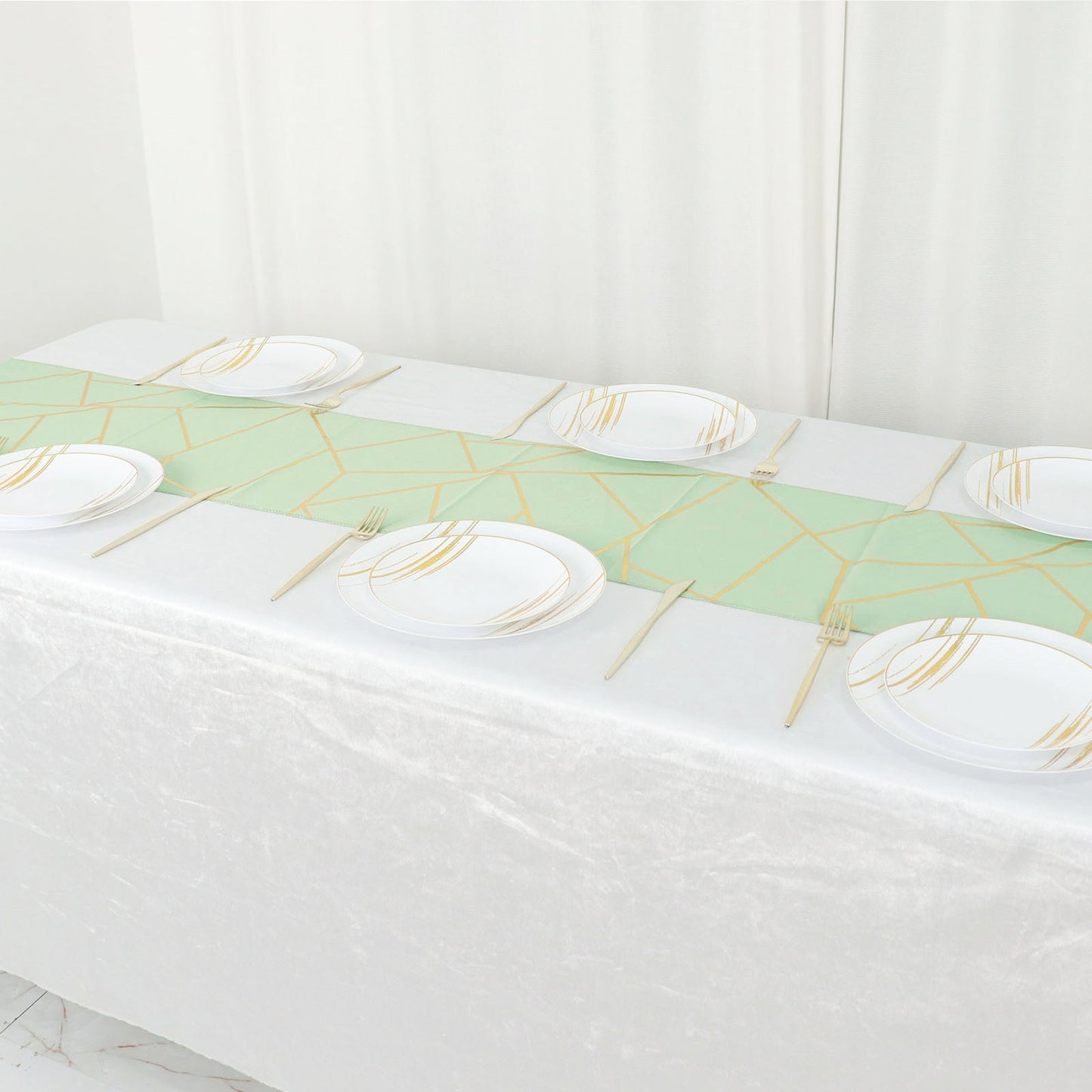 9ft sage green table runner with gold foil geometric pattern on a white table.