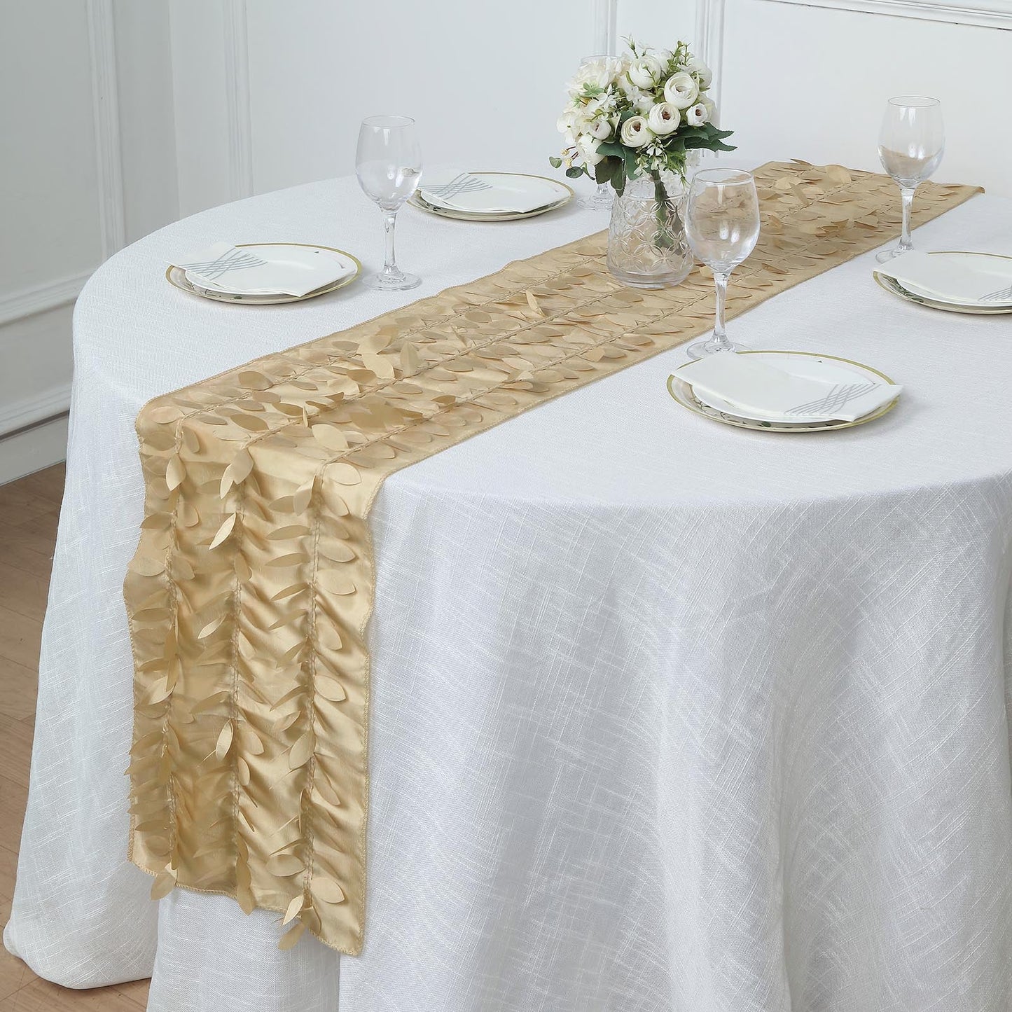 Champagne 3D leaf petal taffeta table runner on a round table.