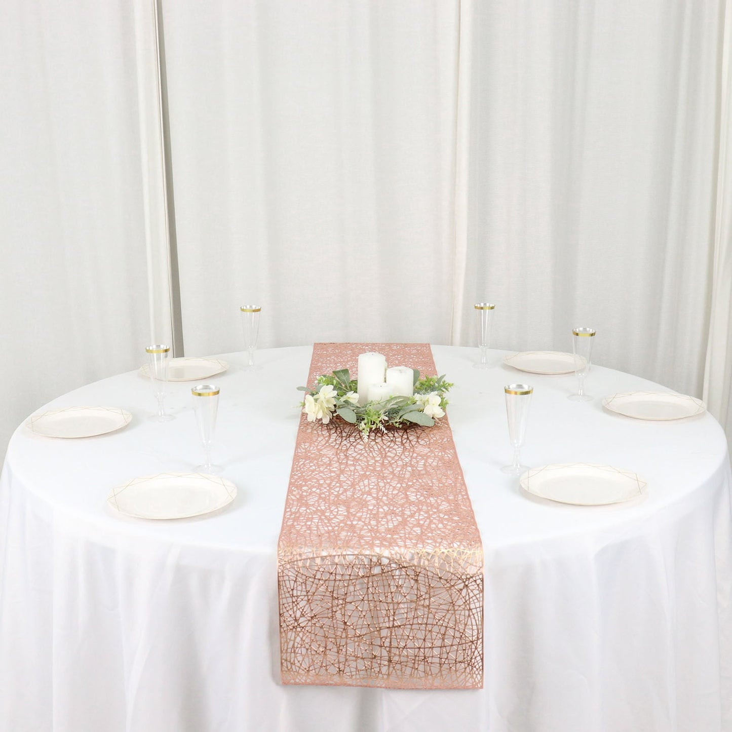 Metallic rose gold reversible table runner on a round white table.