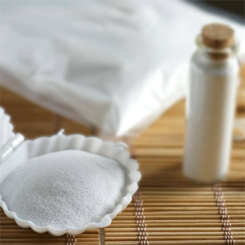 White decorative sand for vase filler in a scalloped dish.