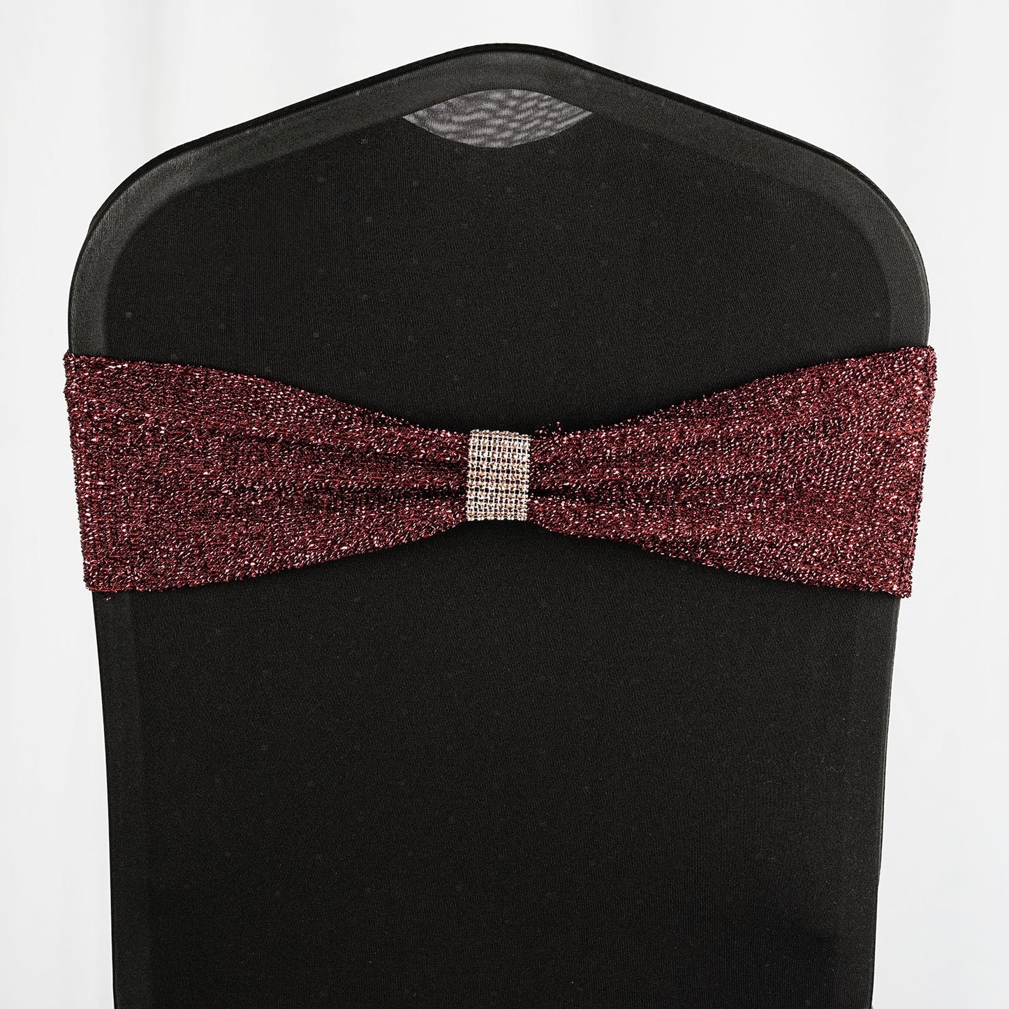 Burgundy metallic shimmer tinsel spandex chair sash on a black chair.