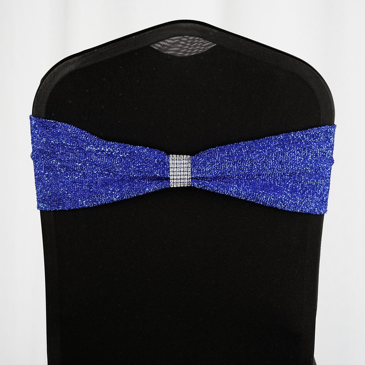 Royal blue metallic shimmer tinsel spandex chair sash on a black chair.