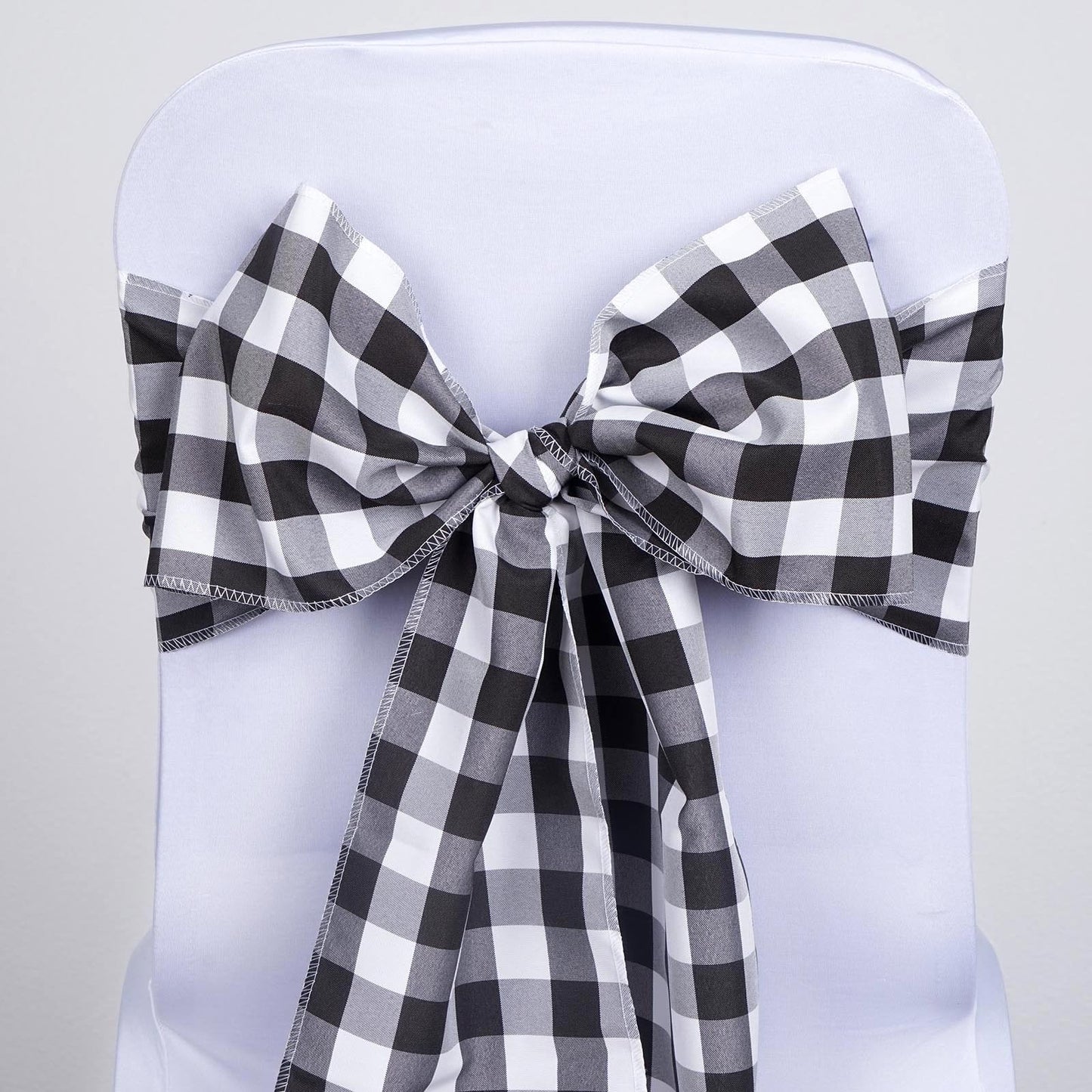 Black and white buffalo plaid checkered chair sashes.