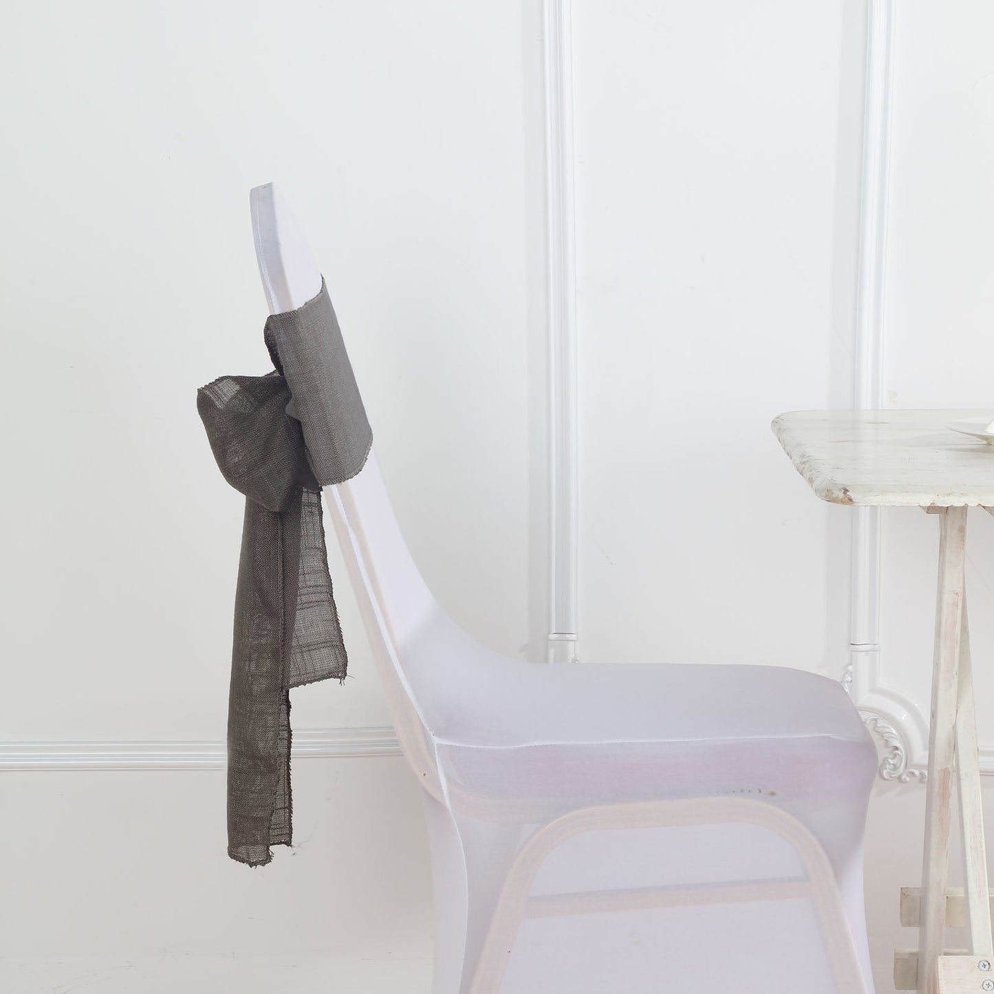 Charcoal gray linen chair sash tied on a chair.
