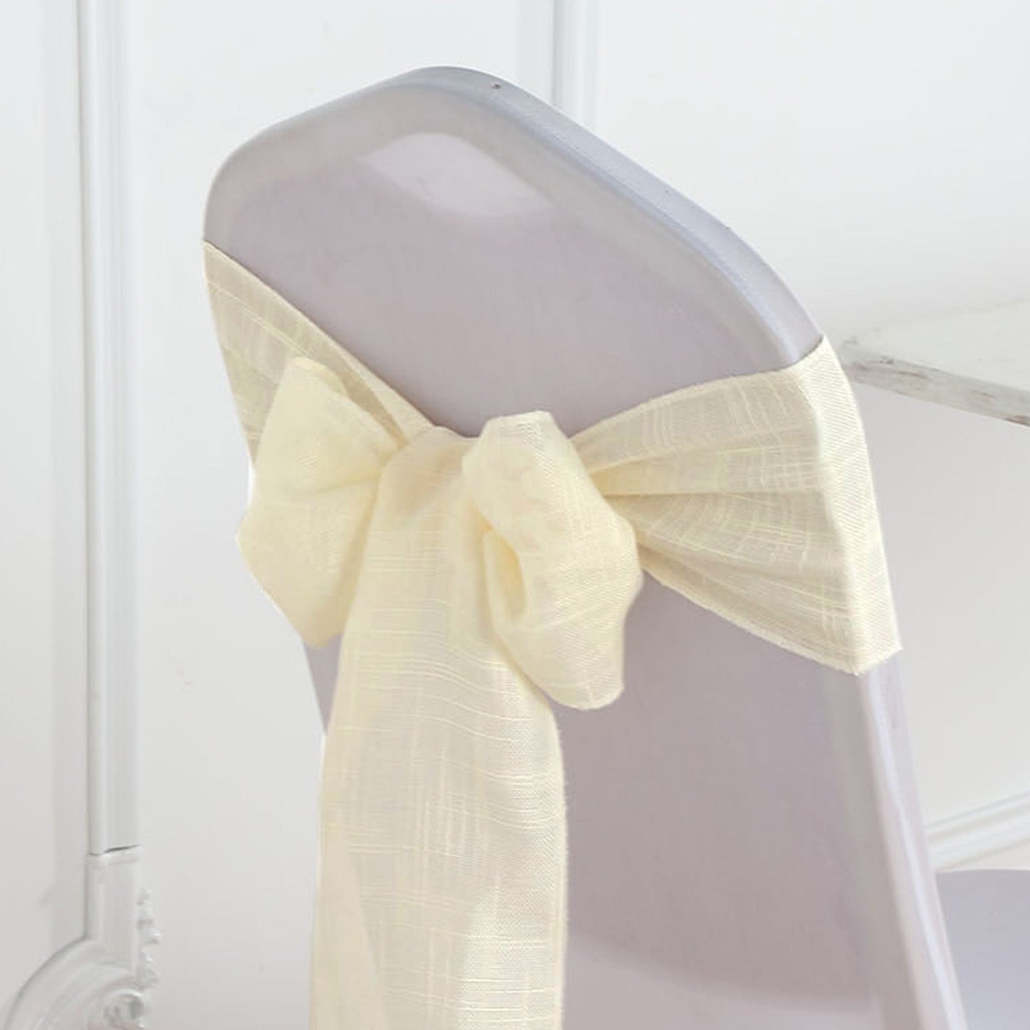 Ivory linen chair sash with slubby texture, wrinkle resistant.