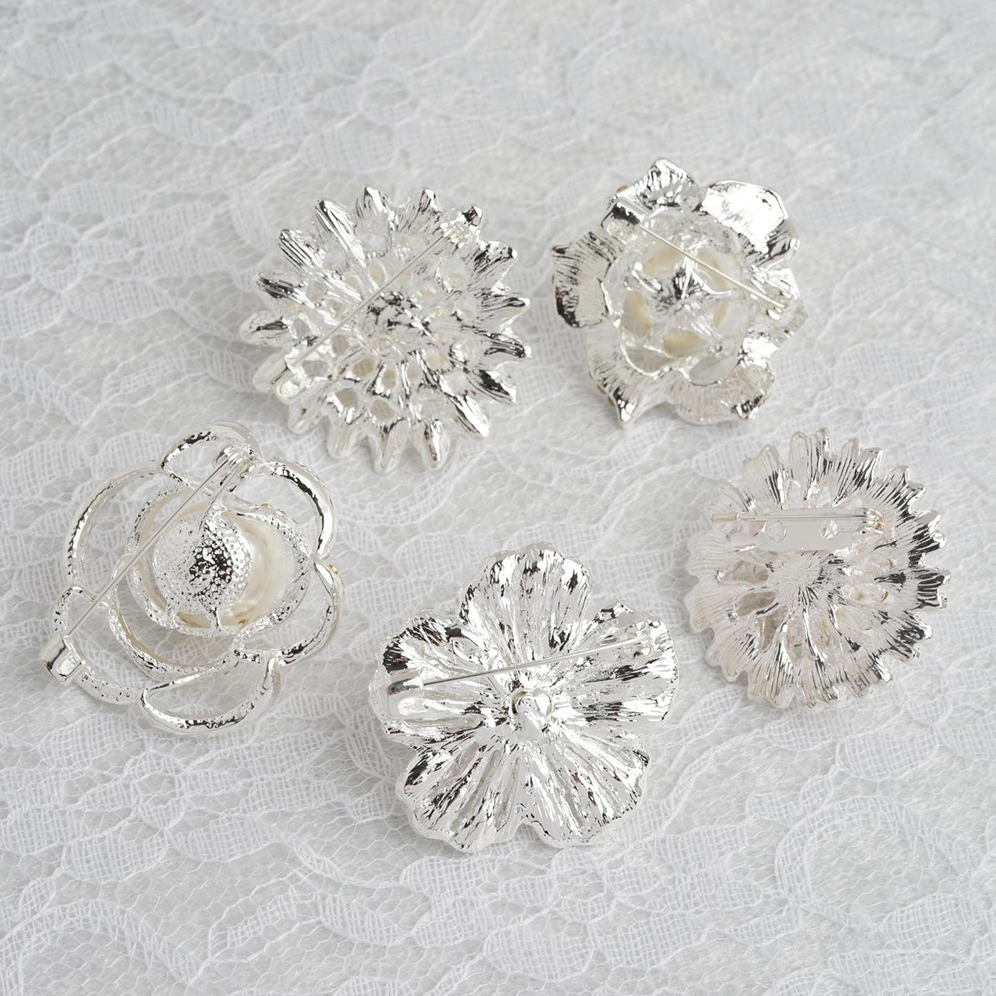 Assorted silver plated rhinestone brooches with pearl centers.