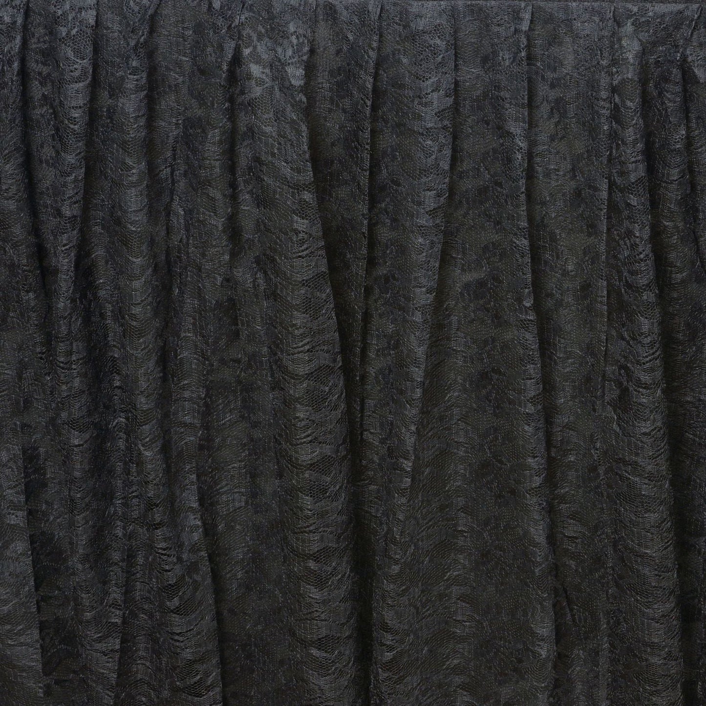 Black pleated lace table skirt for elegant event decor.