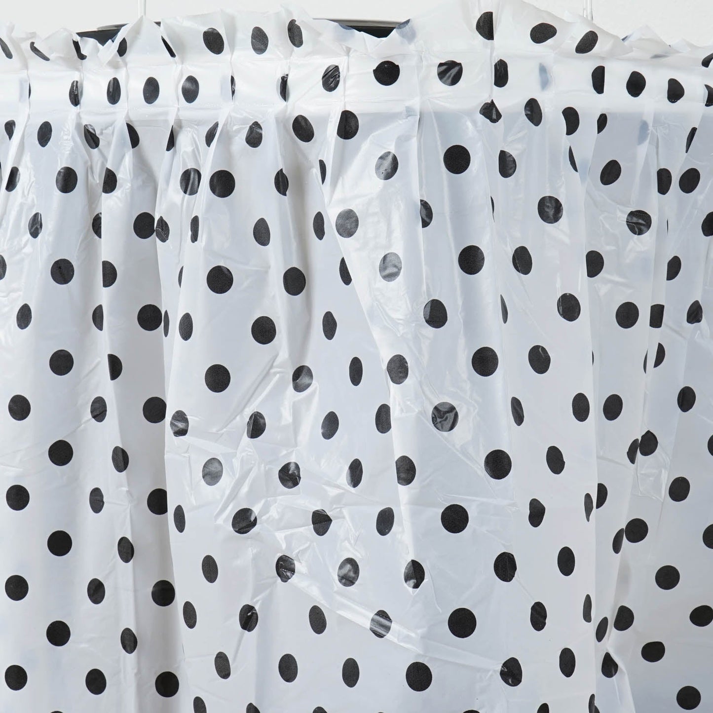 White and black polka dot pleated plastic table skirt, 14FT disposable and spill-proof.