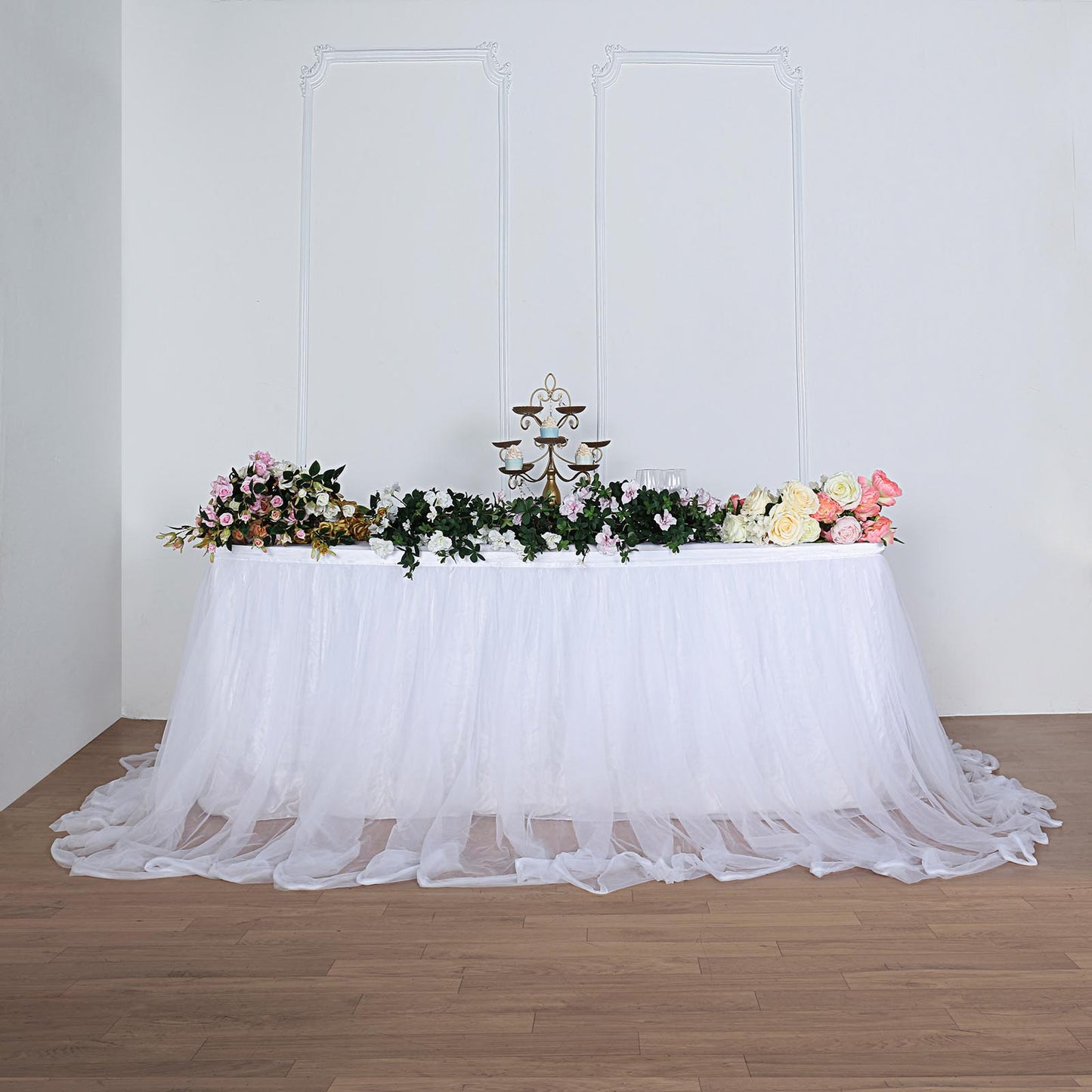 White extra long tulle and satin table skirt with floral decor.