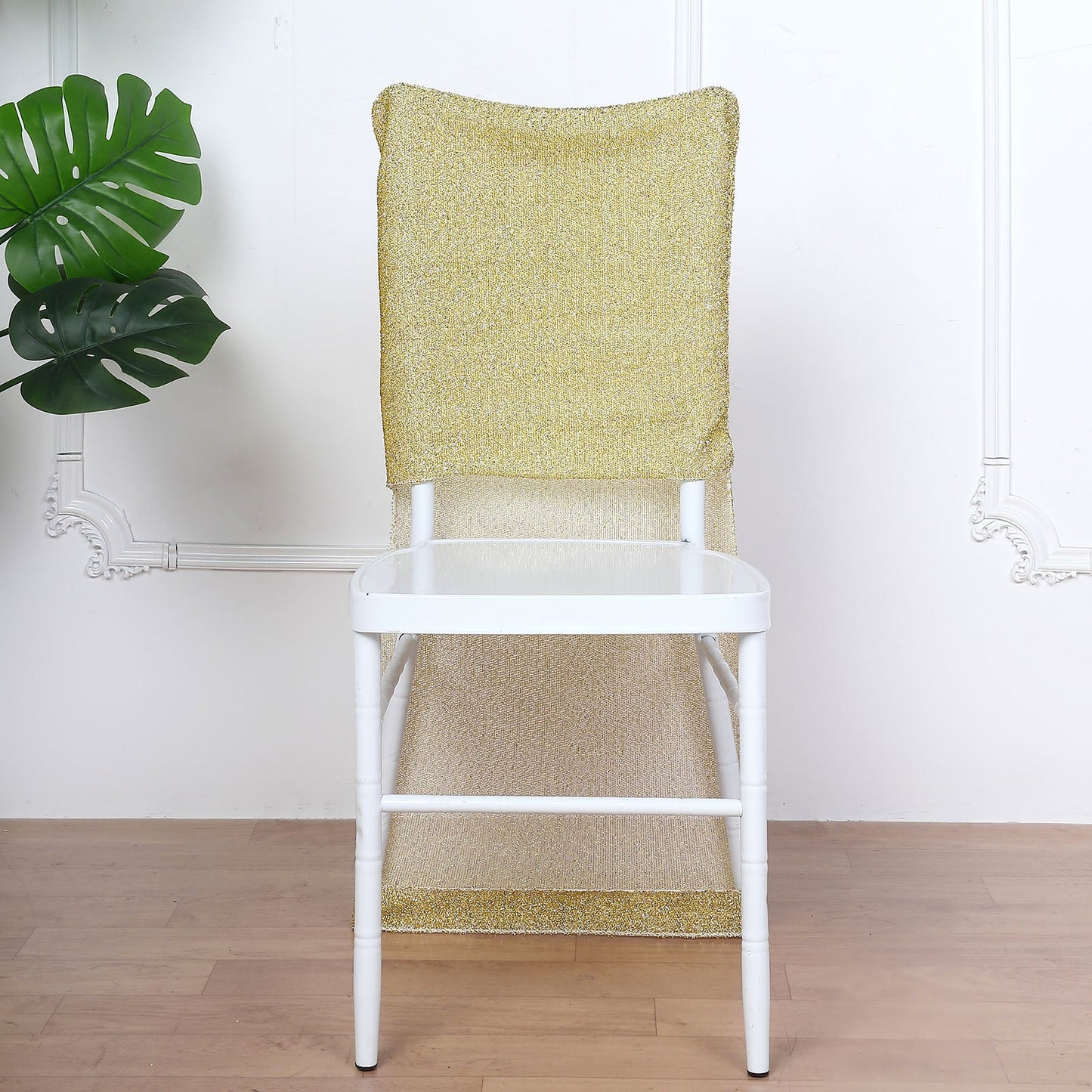 Champagne metallic shimmer tinsel spandex stretch chair slipcover on a white chair.