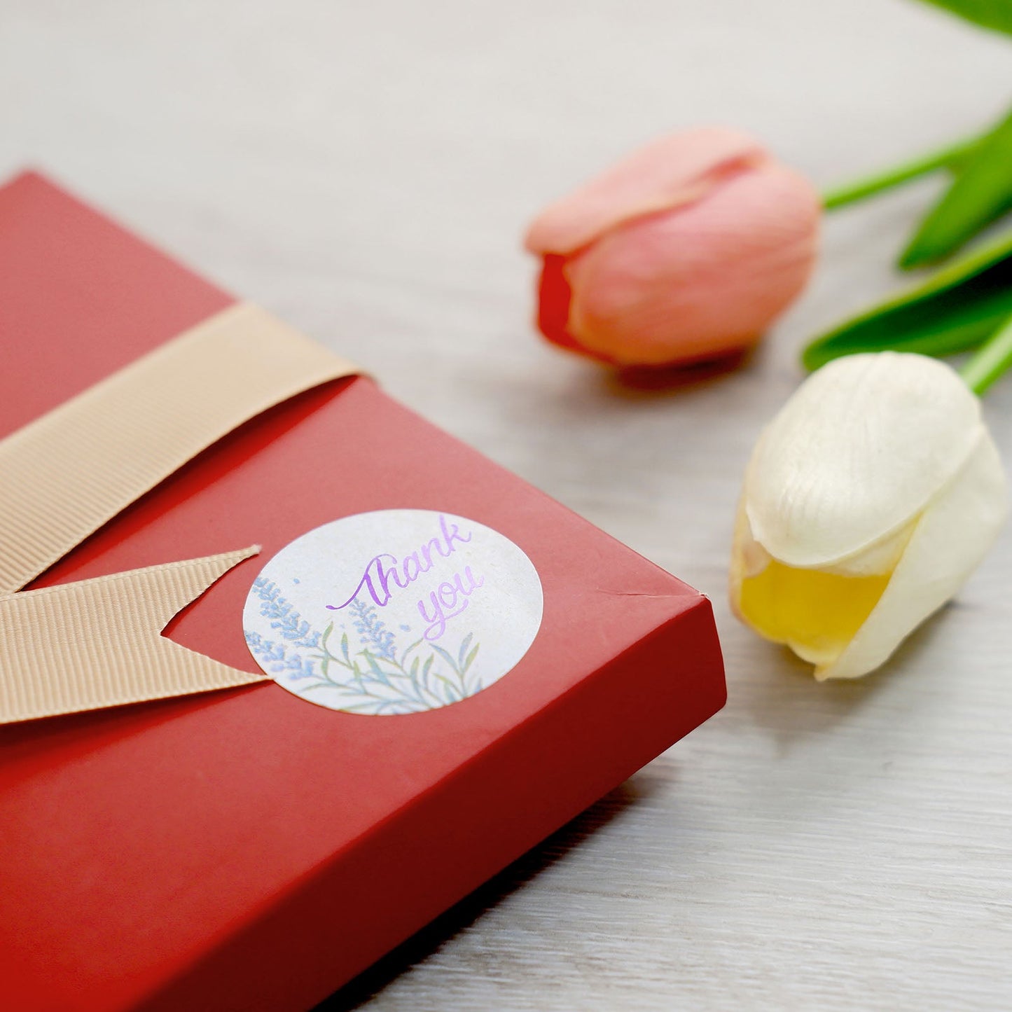 Purple lavender thank you sticker on a red gift box.