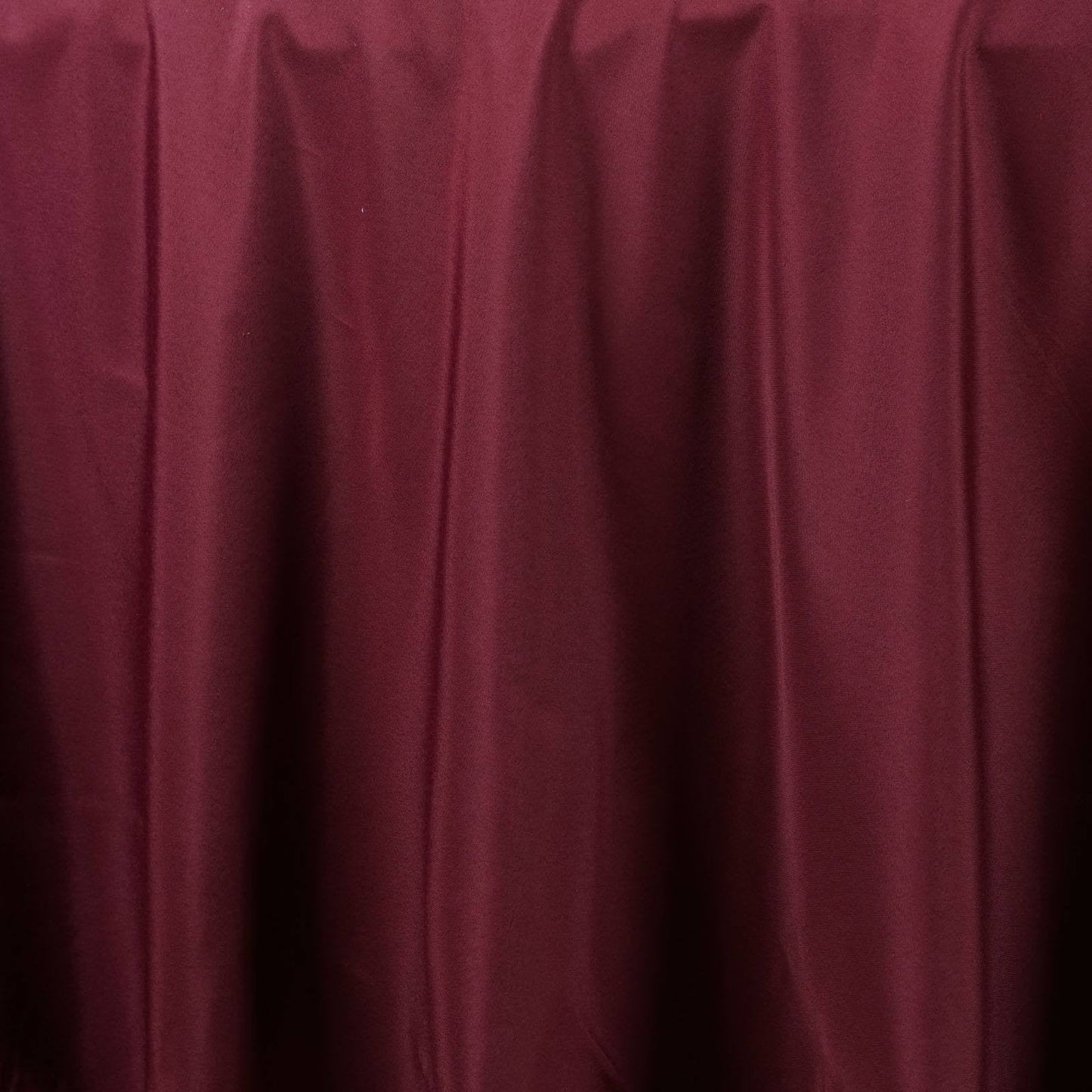 Burgundy seamless polyester round tablecloth.