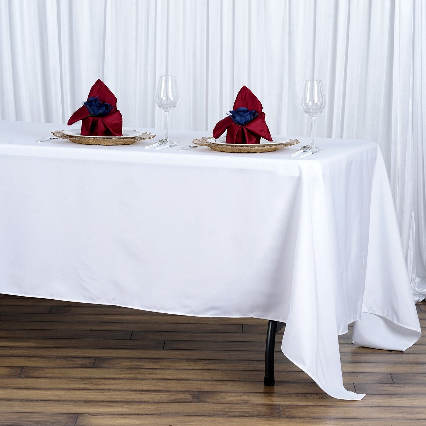 White premium polyester rectangular tablecloth on a dining table.