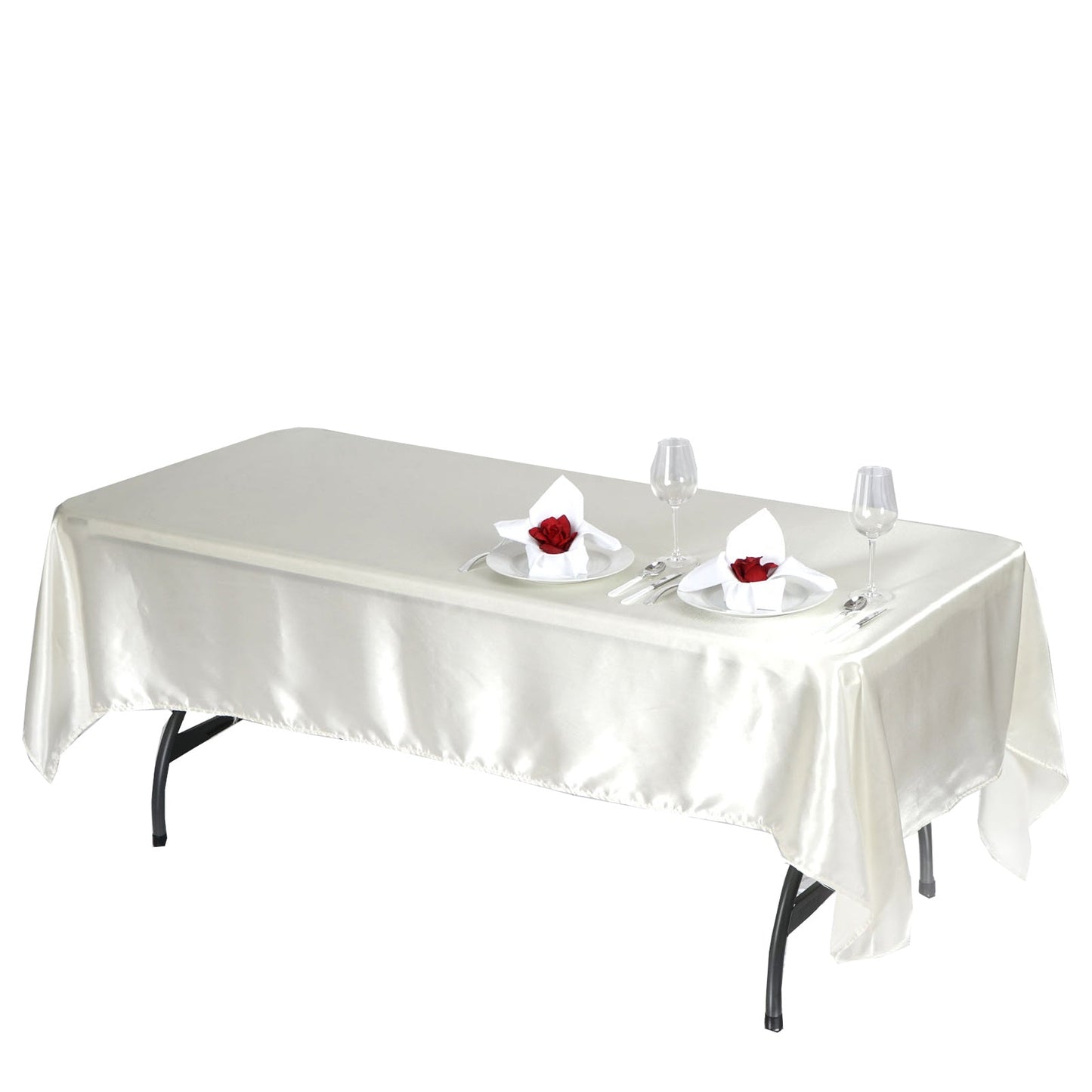 Ivory satin rectangular tablecloth on a dining table with elegant settings.