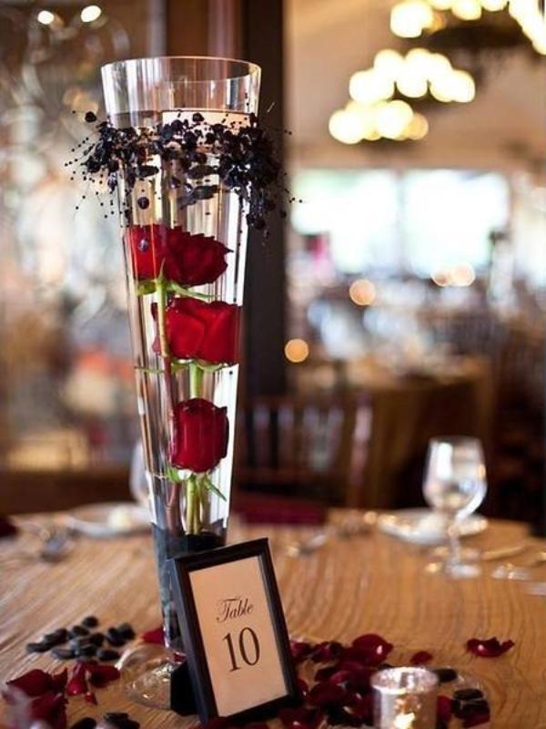 Clear heavy-duty trumpet glass vase with red roses, elegant table centerpiece.