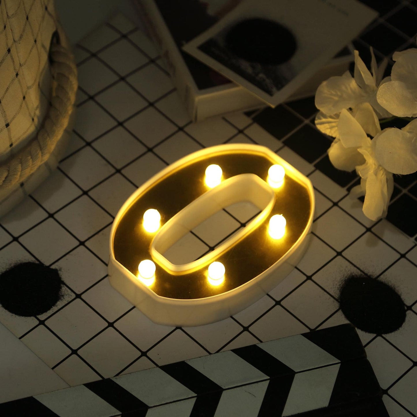 Gold 3D marquee number "0" with warm white LED lights.