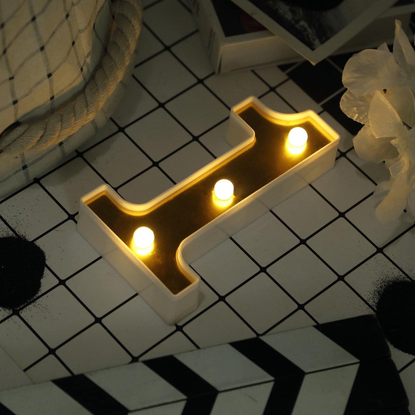 Gold 3D marquee number "1" with warm white LED lights.