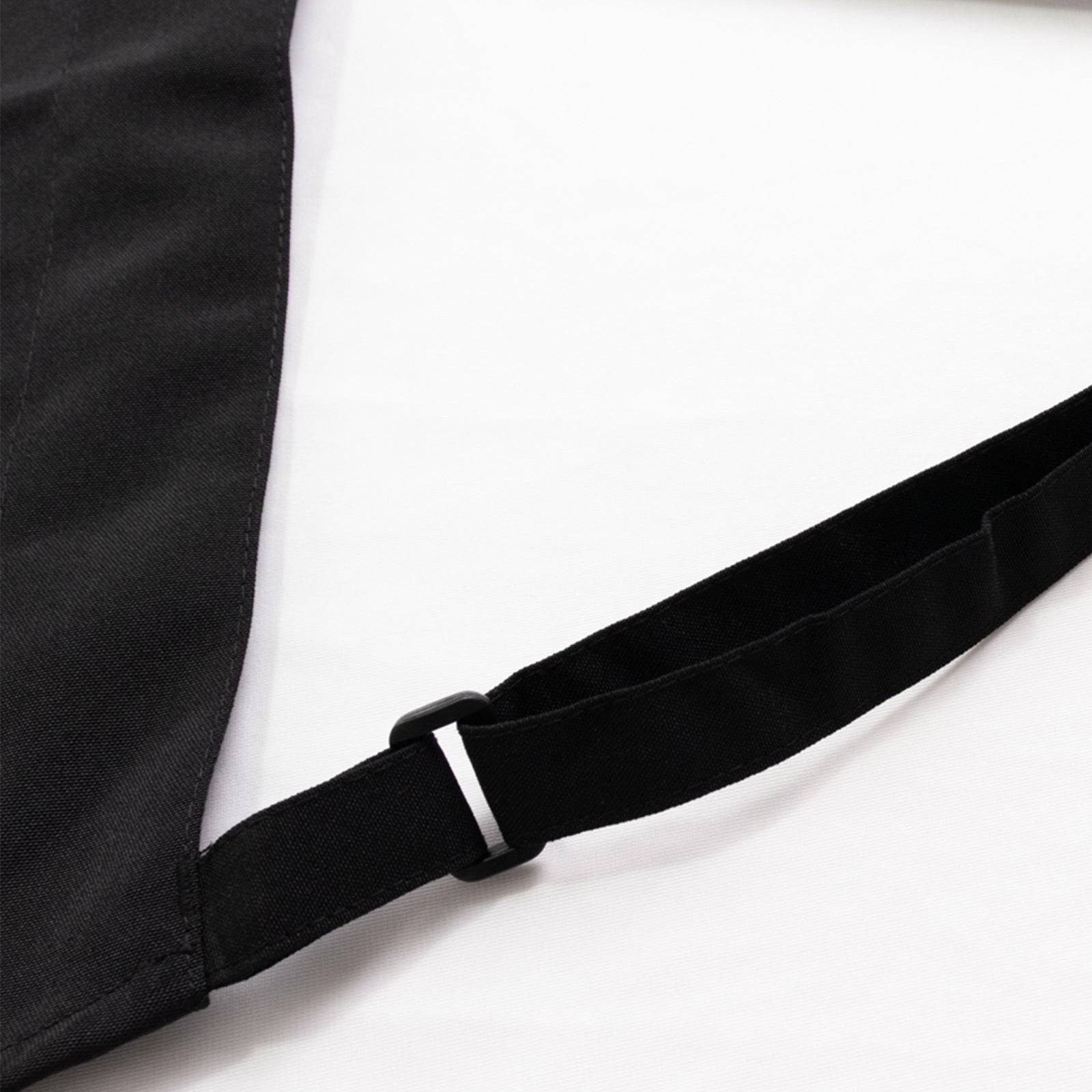 Black cooking chef apron with adjustable neck and long ties.