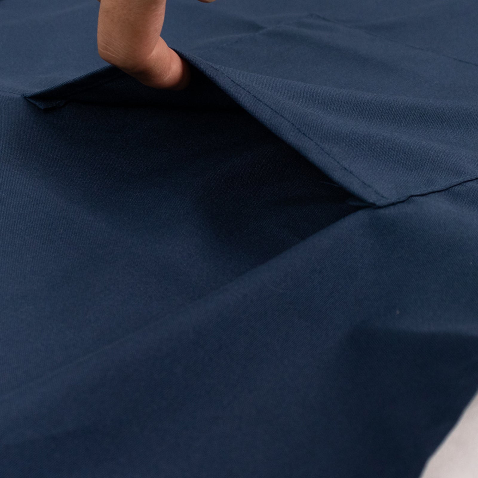 Navy blue premium polyester cooking chef apron with pockets.