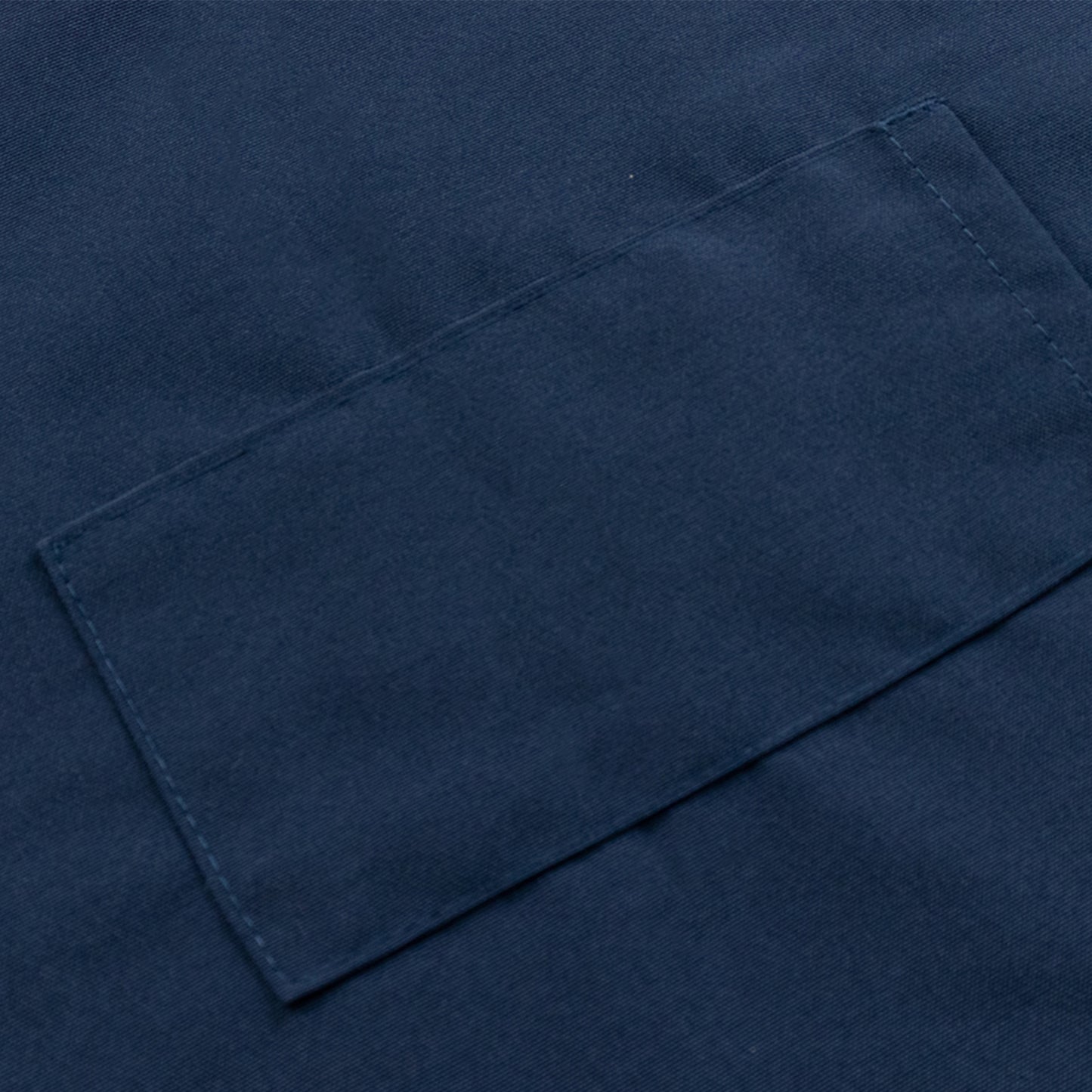 Navy blue cooking chef apron with adjustable neck and two pockets.