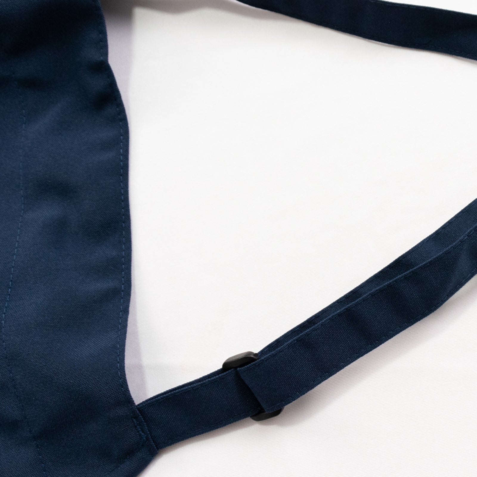 Navy blue premium polyester cooking chef apron with adjustable neck and long ties.