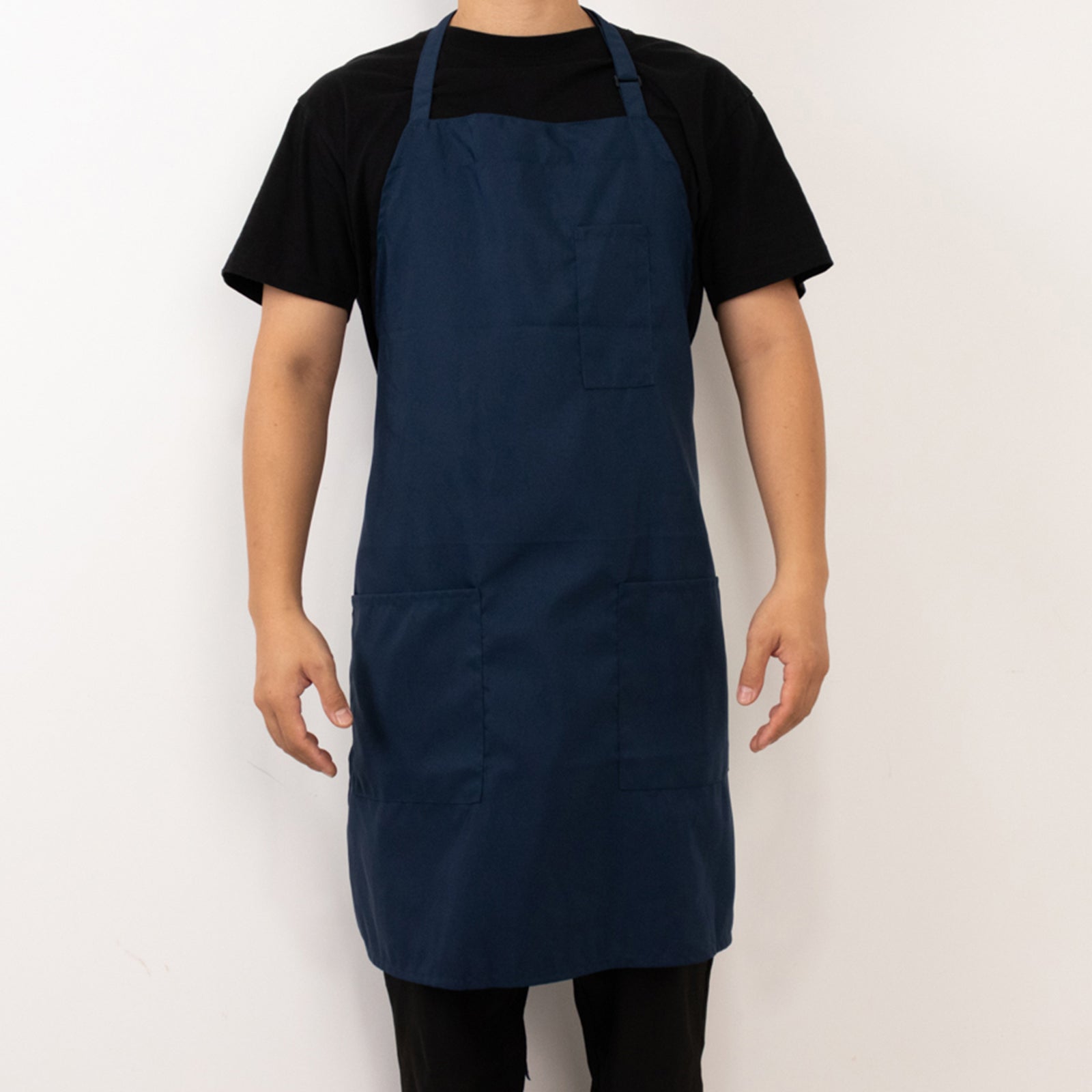Navy blue premium polyester chef apron with adjustable neck and two pockets.