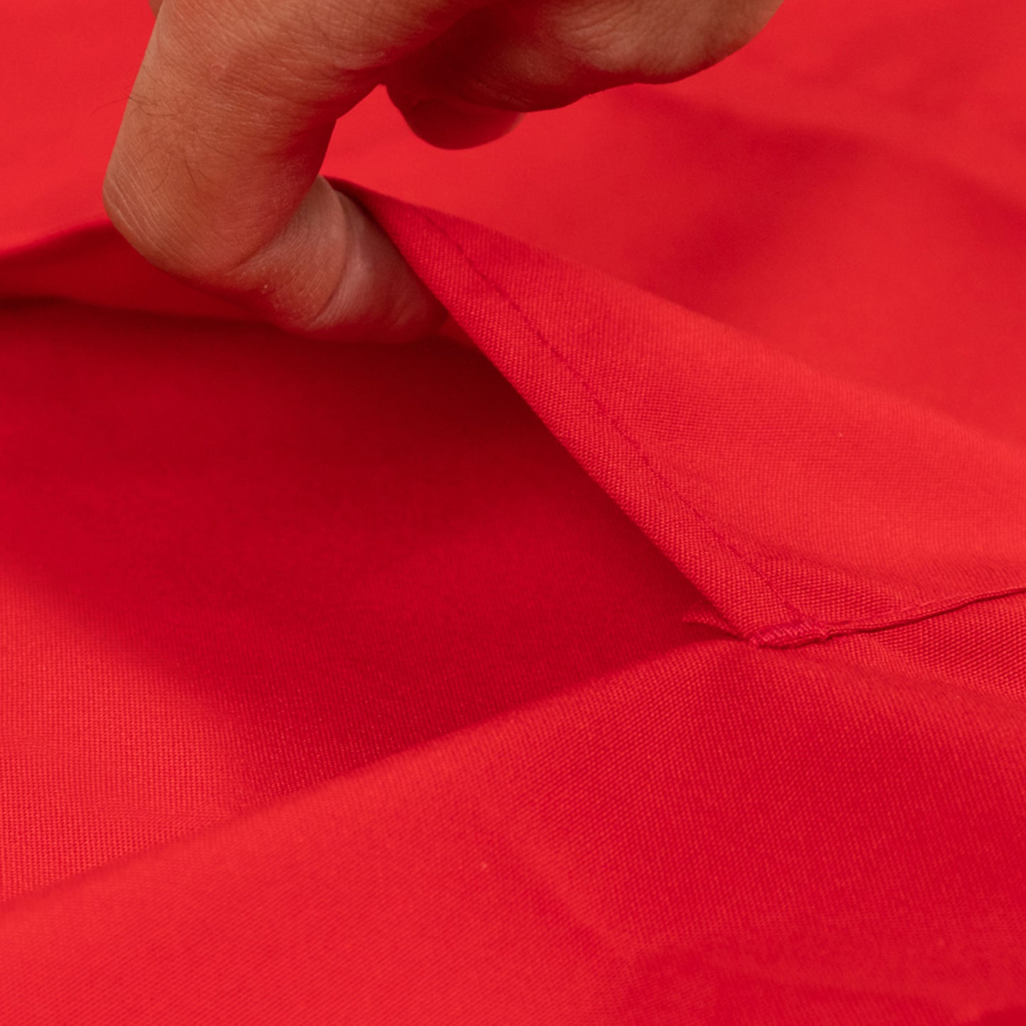 Red cooking chef apron with adjustable neck and long ties.