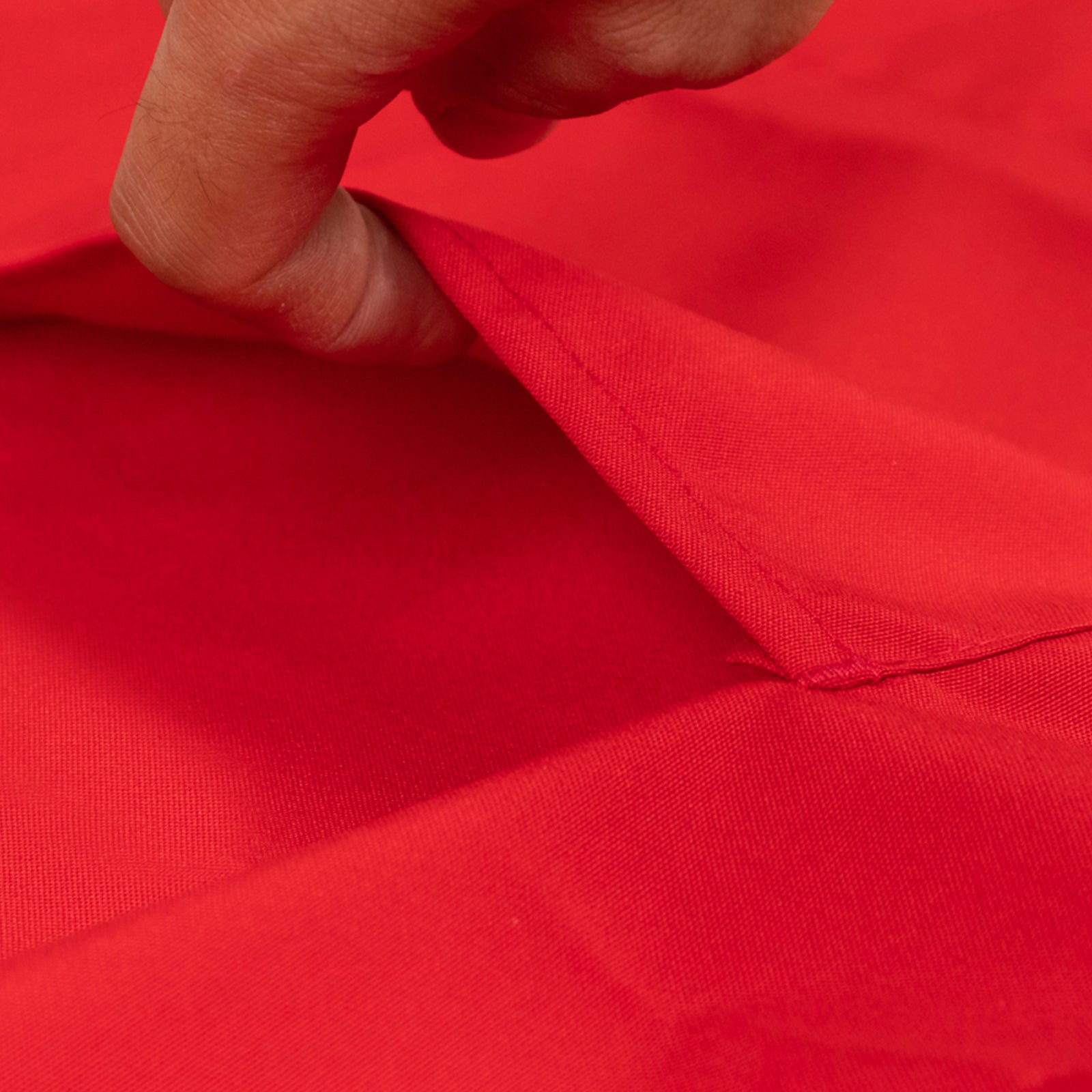 Red cooking chef apron with adjustable neck and long ties.
