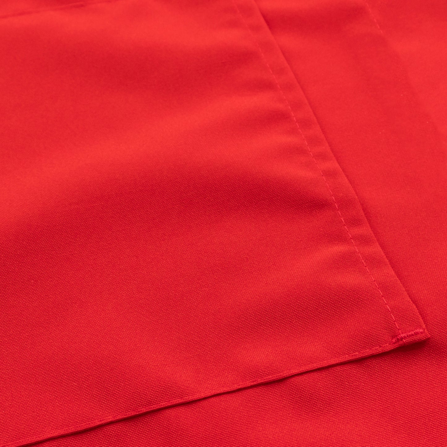 Red cooking chef apron with adjustable neck and long ties, featuring two pockets.