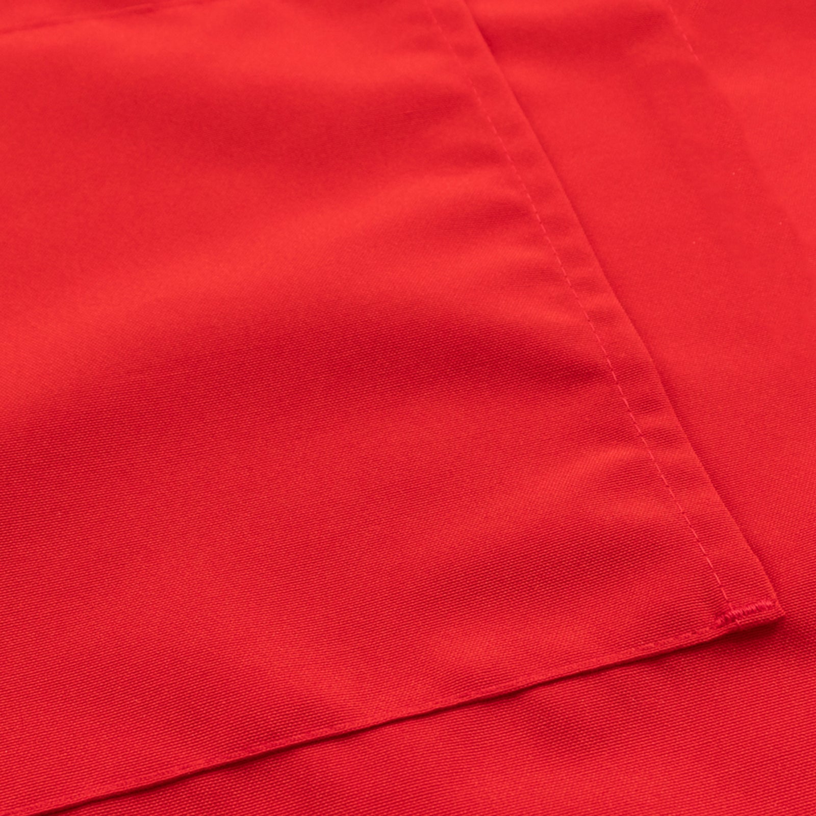 Red cooking chef apron with adjustable neck and long ties, featuring two pockets.