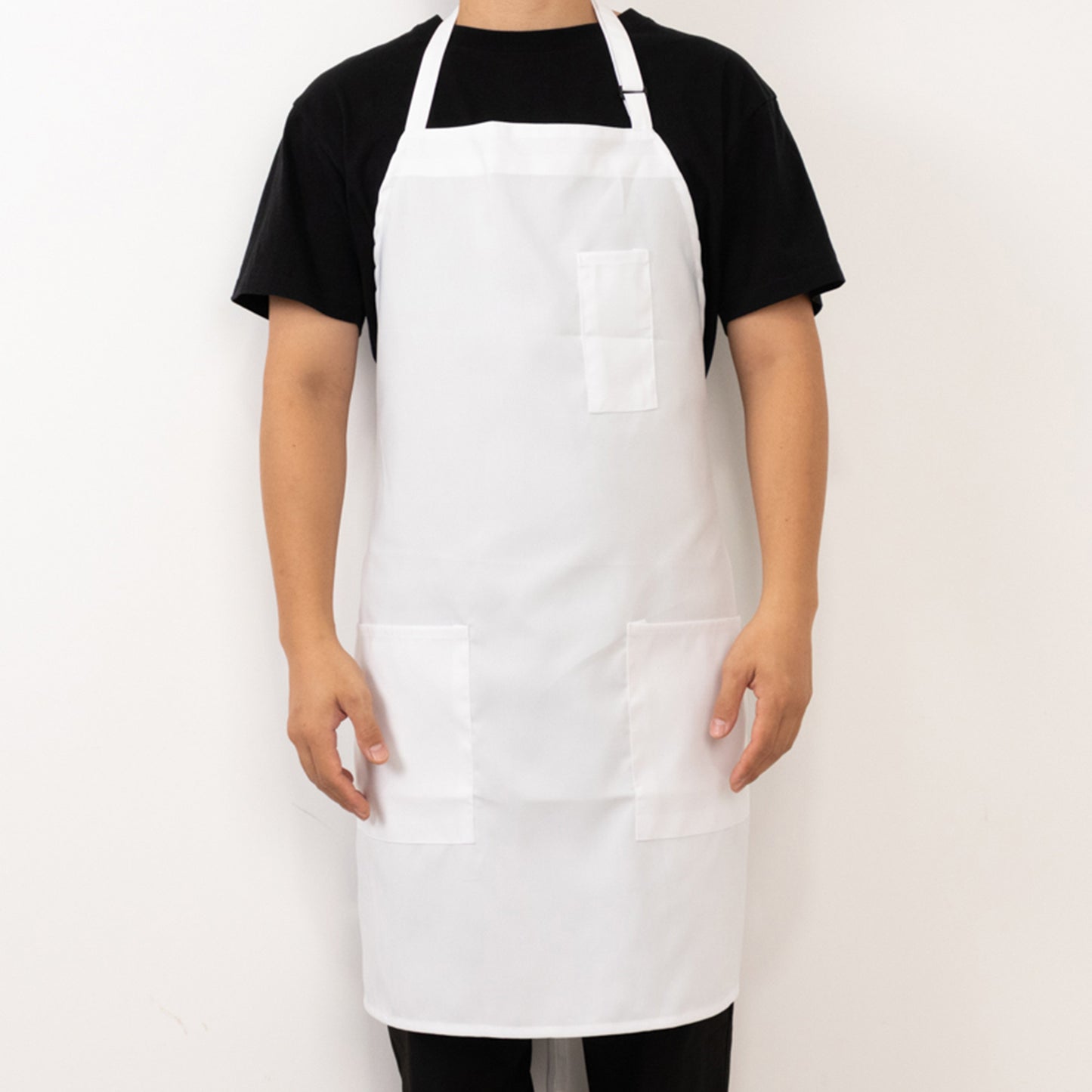 White polyester cooking chef apron with adjustable neck and pockets.