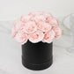 Blush rose centerpiece arrangement in a black round gift box.