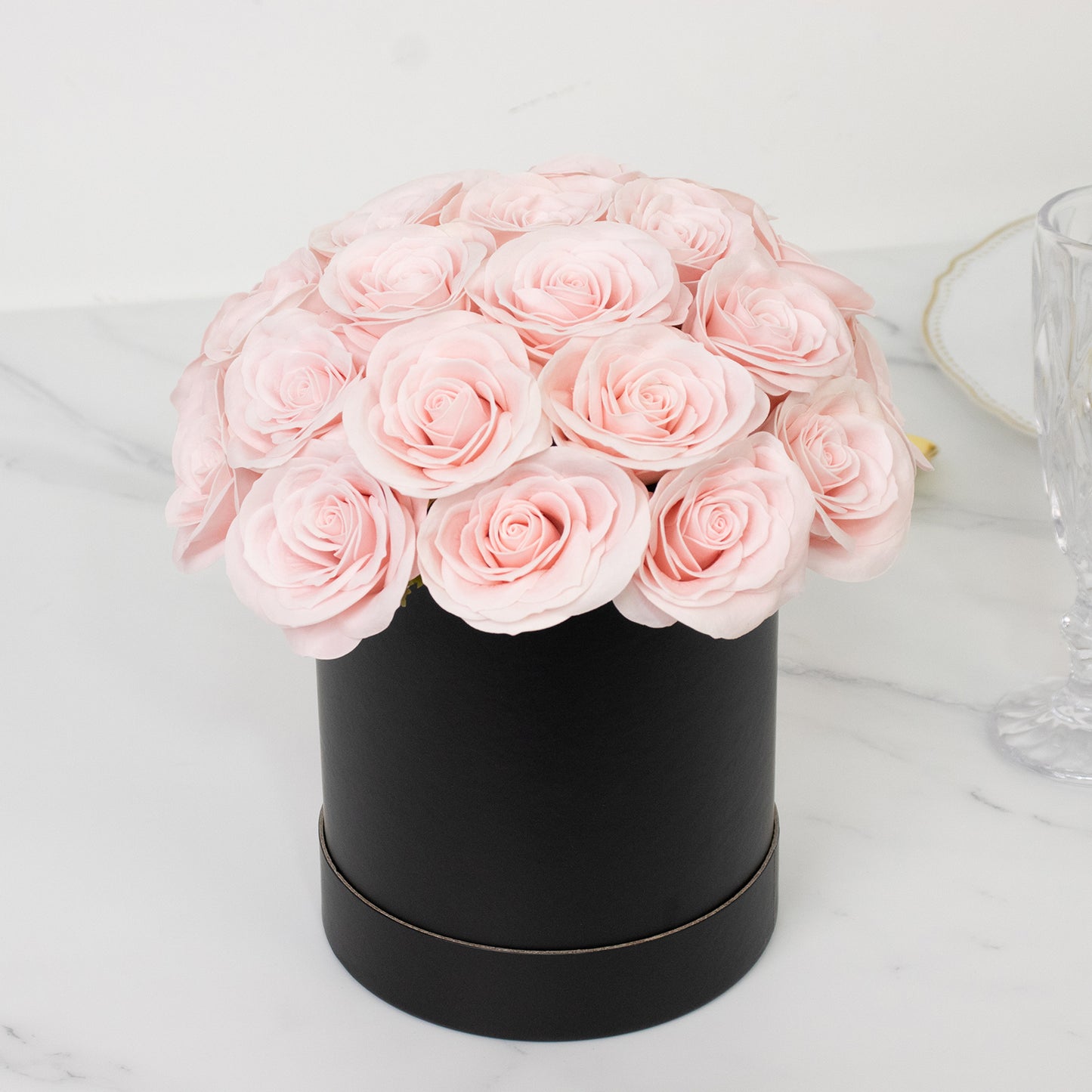 Blush rose centerpiece arrangement in a black round gift box.