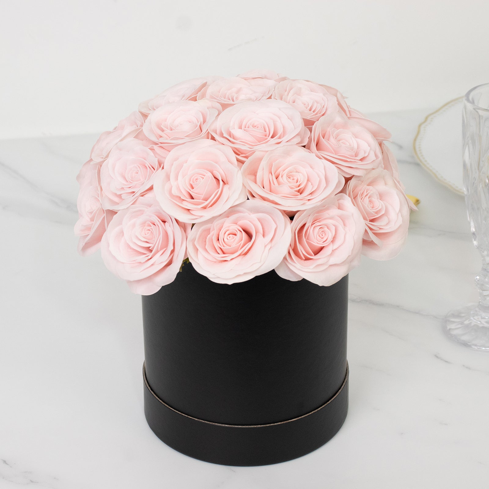 Blush rose centerpiece arrangement in a black round gift box.
