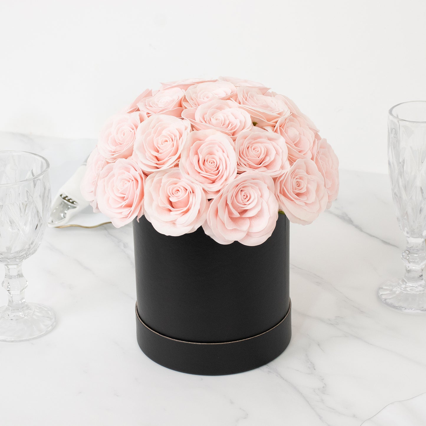 Blush rose centerpiece arrangement in a black round gift box.