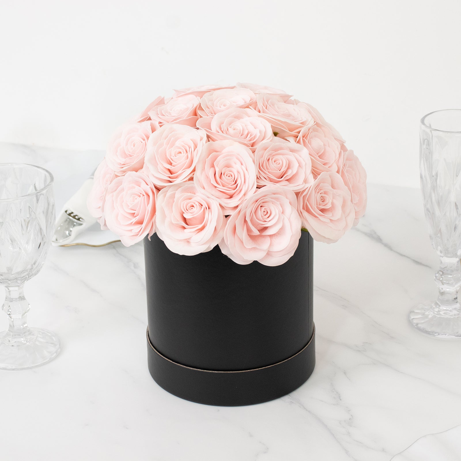 Blush rose centerpiece arrangement in a black round gift box.