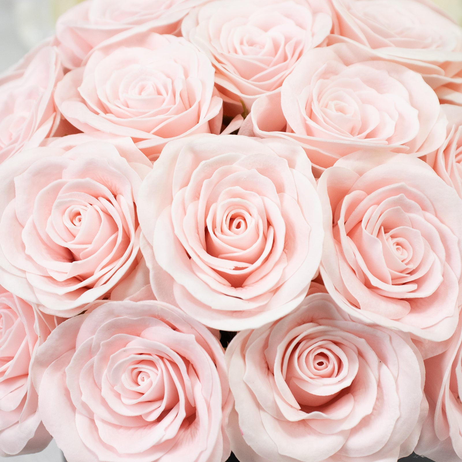 Blush pink rose centerpiece arrangement in a black gift box.