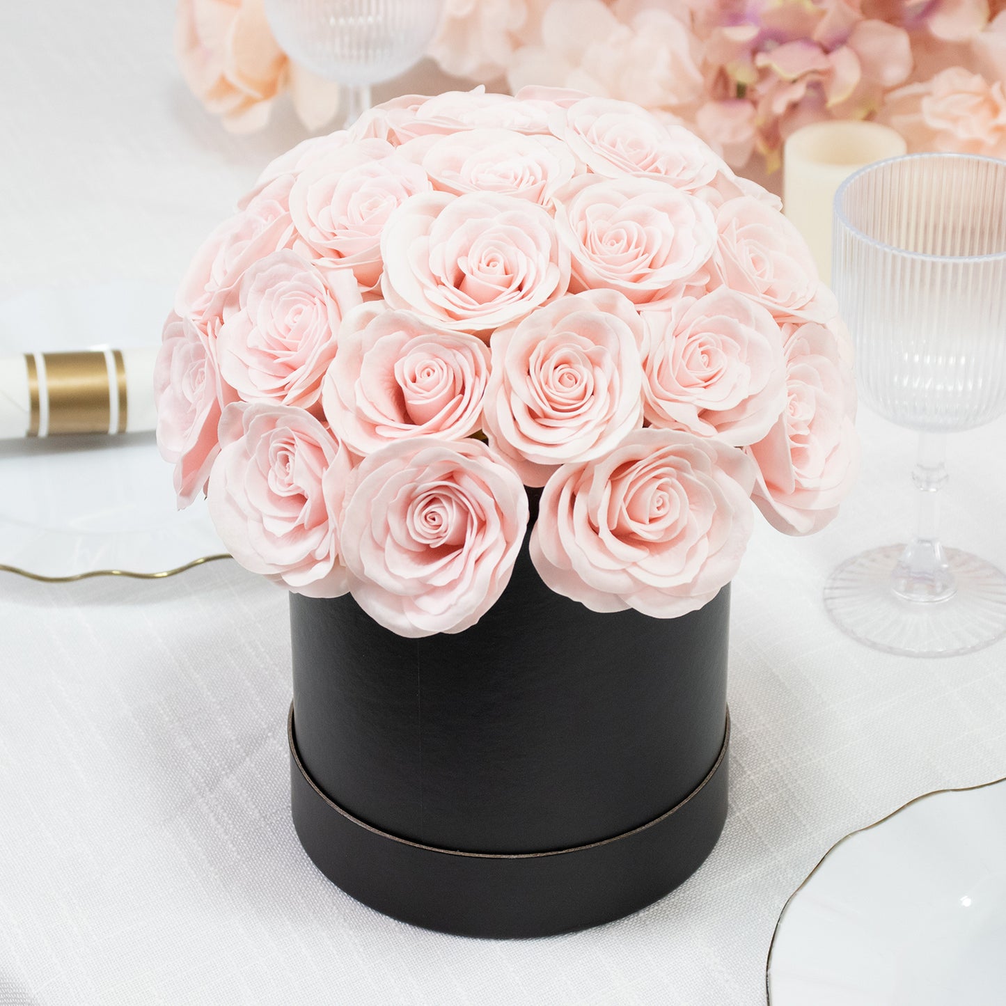 Blush rose centerpiece arrangement in a black round gift box.