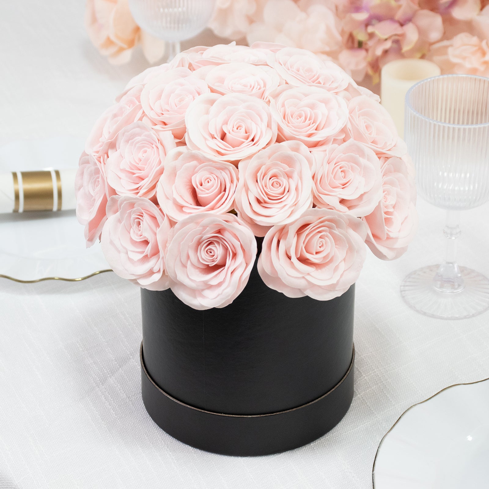 Blush rose centerpiece arrangement in a black round gift box.