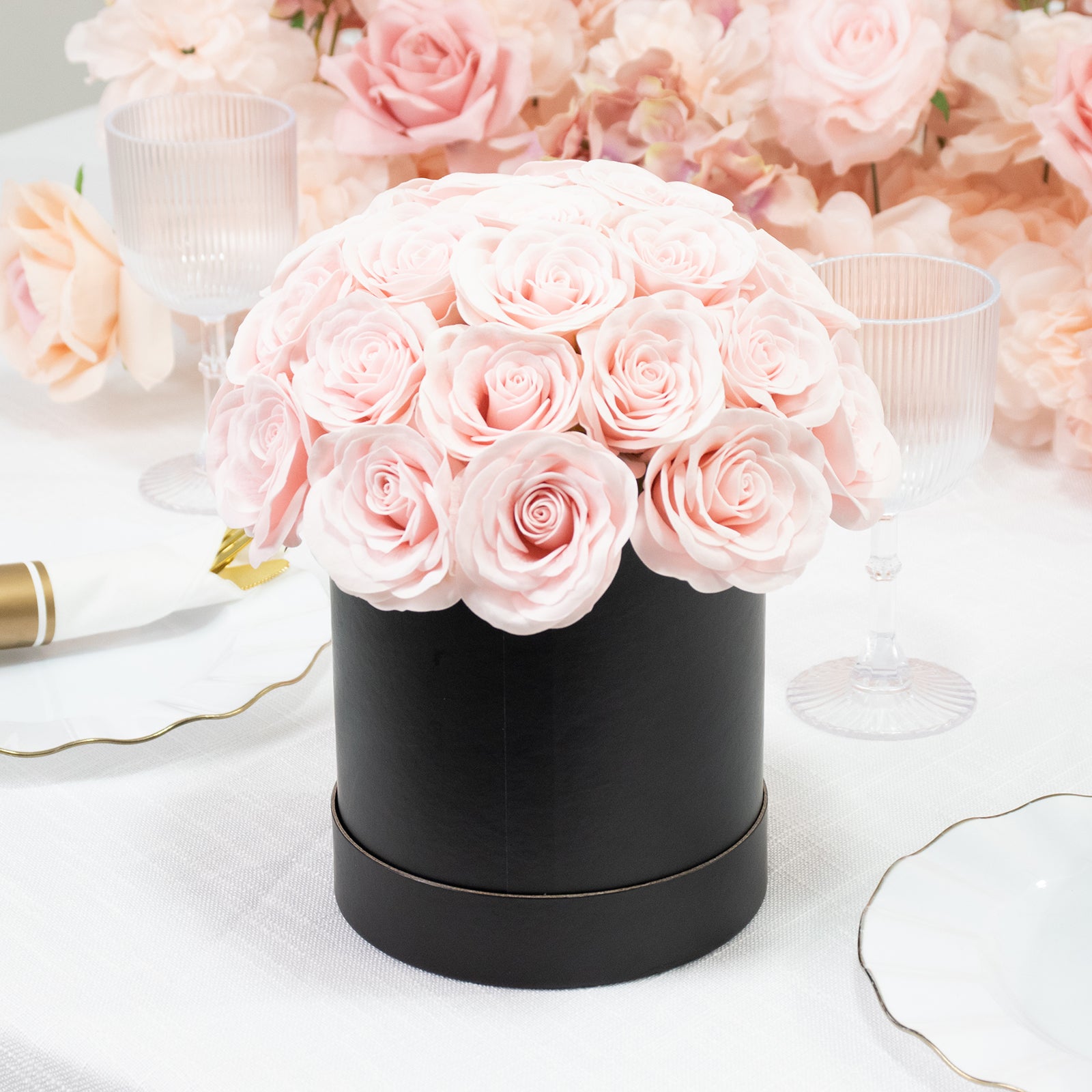 Blush rose centerpiece arrangement in a black round gift box.