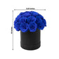 Royal blue rose centerpiece arrangement in a black round gift box.