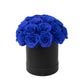Royal blue rose centerpiece arrangement in a black round gift box.