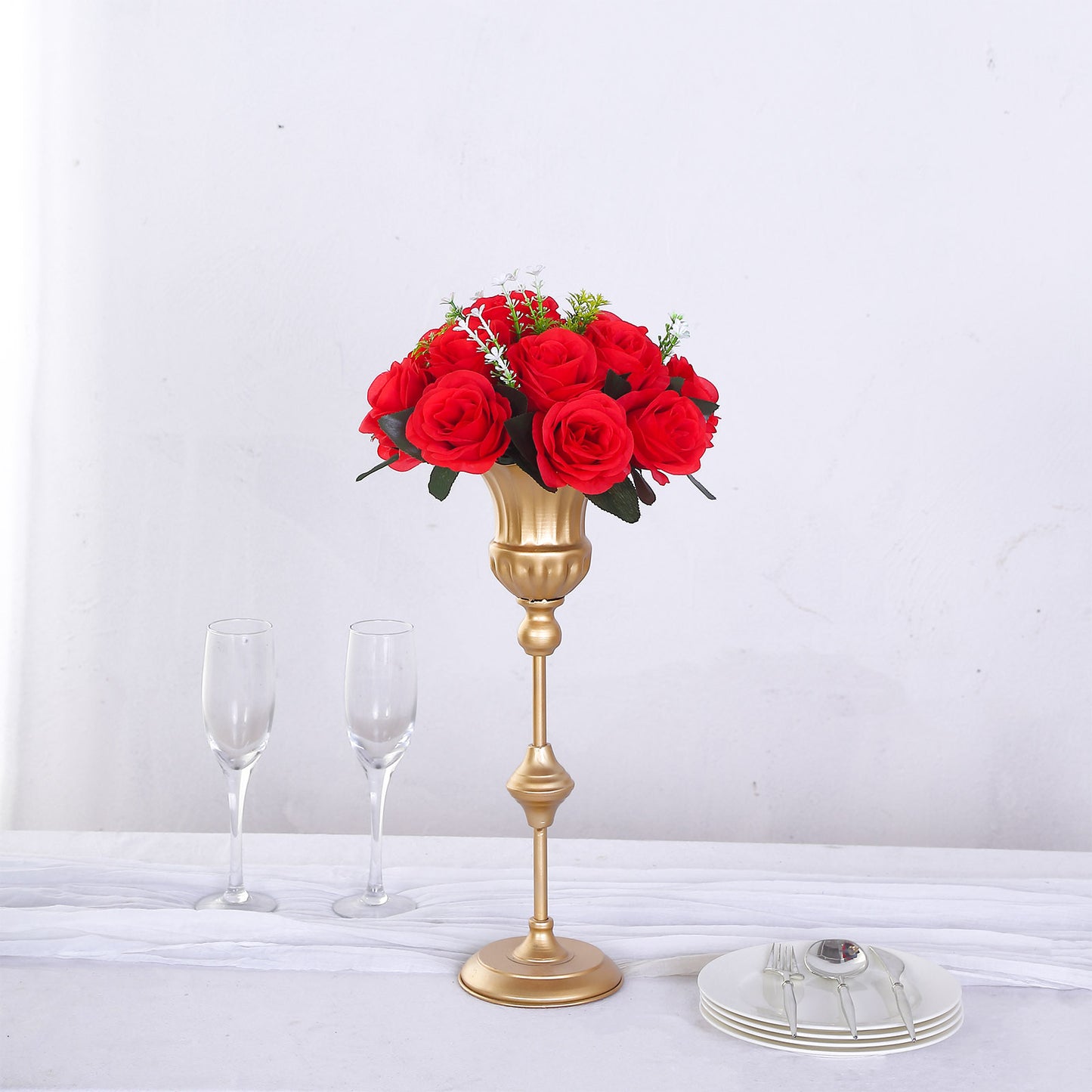Red silk rose flower ball centerpiece in a gold vase.