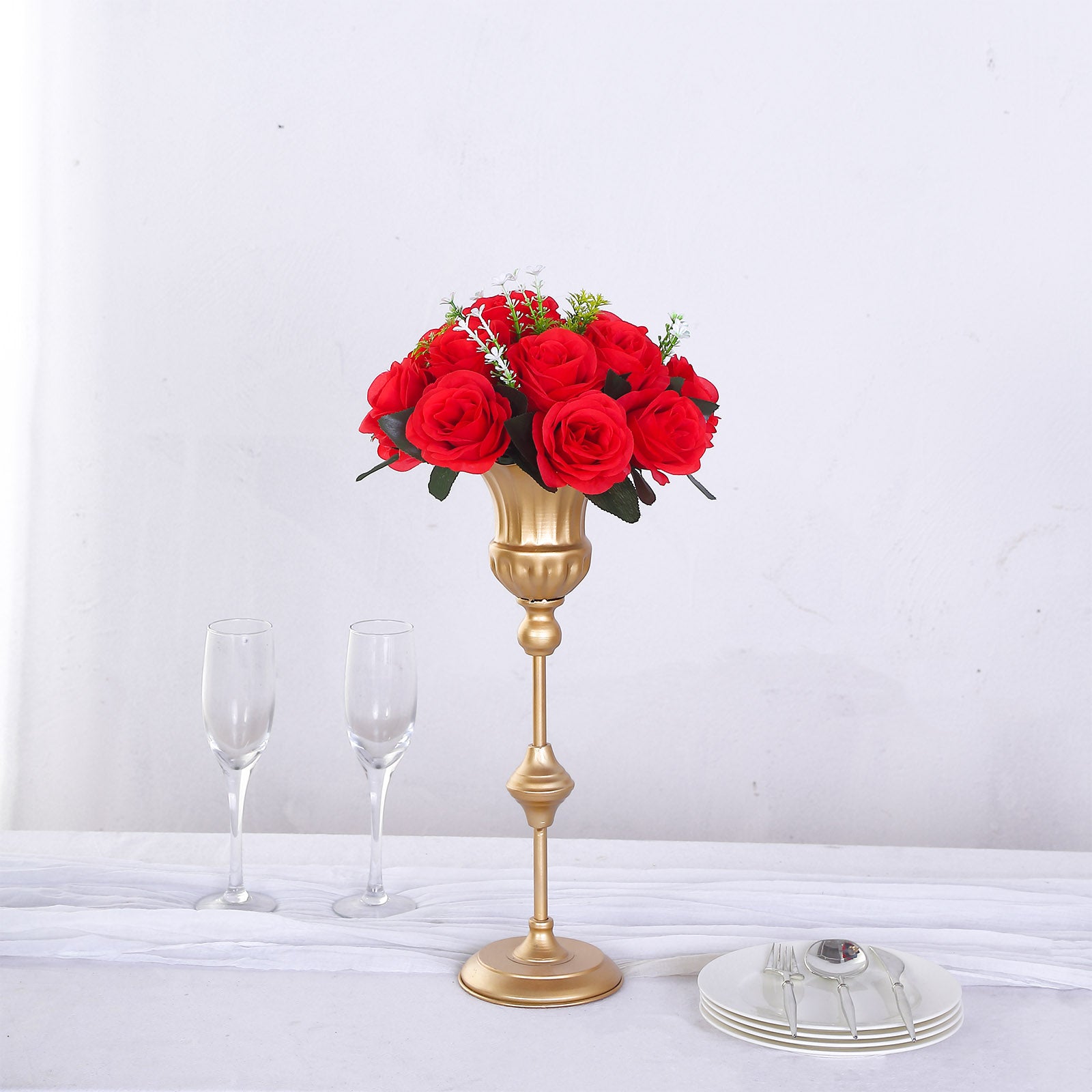Red silk rose flower ball centerpiece in a gold vase.