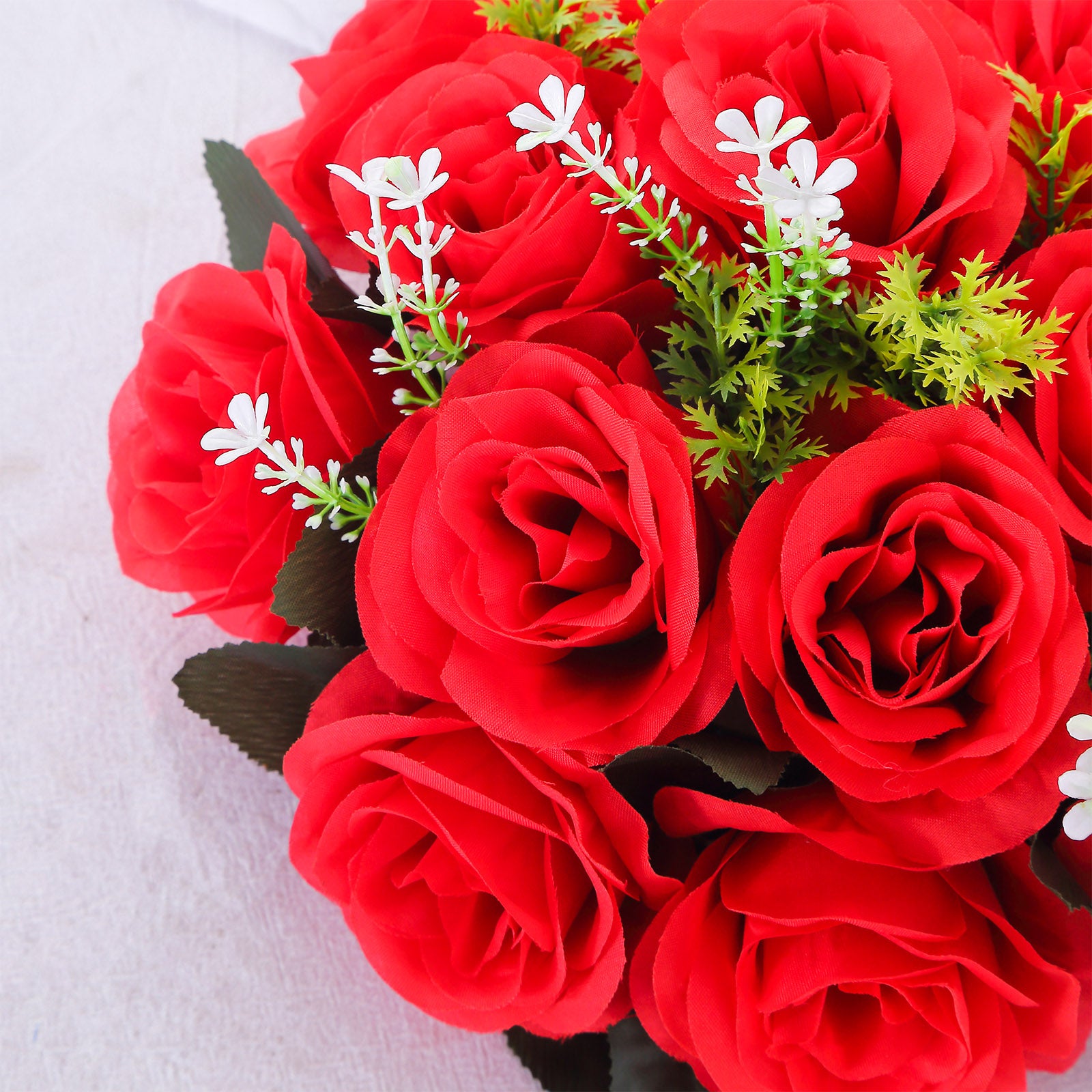 Red silk rose flower ball centerpiece arrangement with green accents.