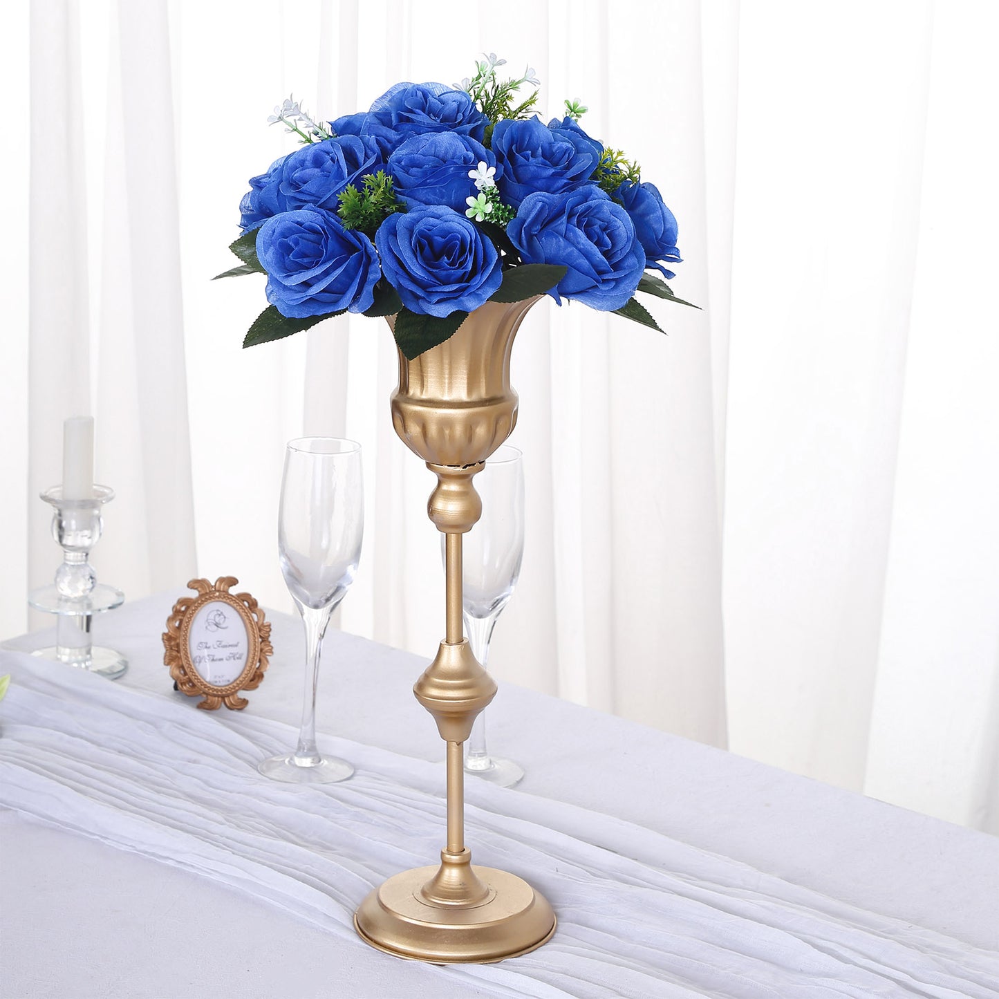 Royal blue silk rose flower ball centerpiece arrangement in a gold vase.